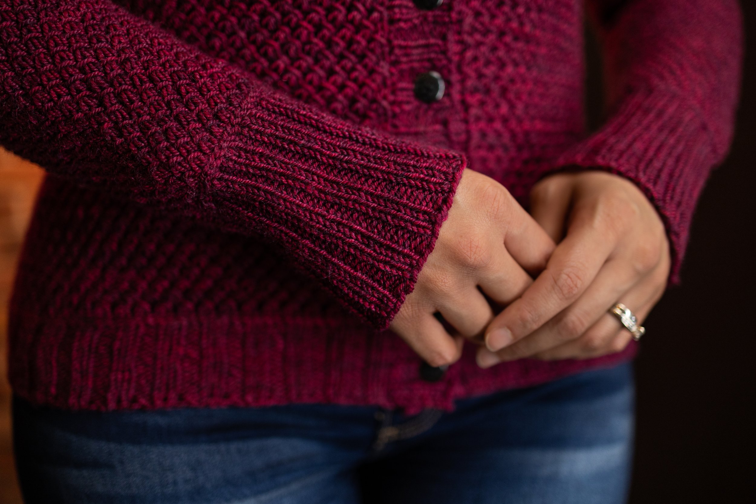 Detail shot of the long sleeves and ribbed cuffs framed by easy-to-knit lateral braids on the full-length Nydia Cardigan, designed for women in petite to plus sizes with lots of fit customization.