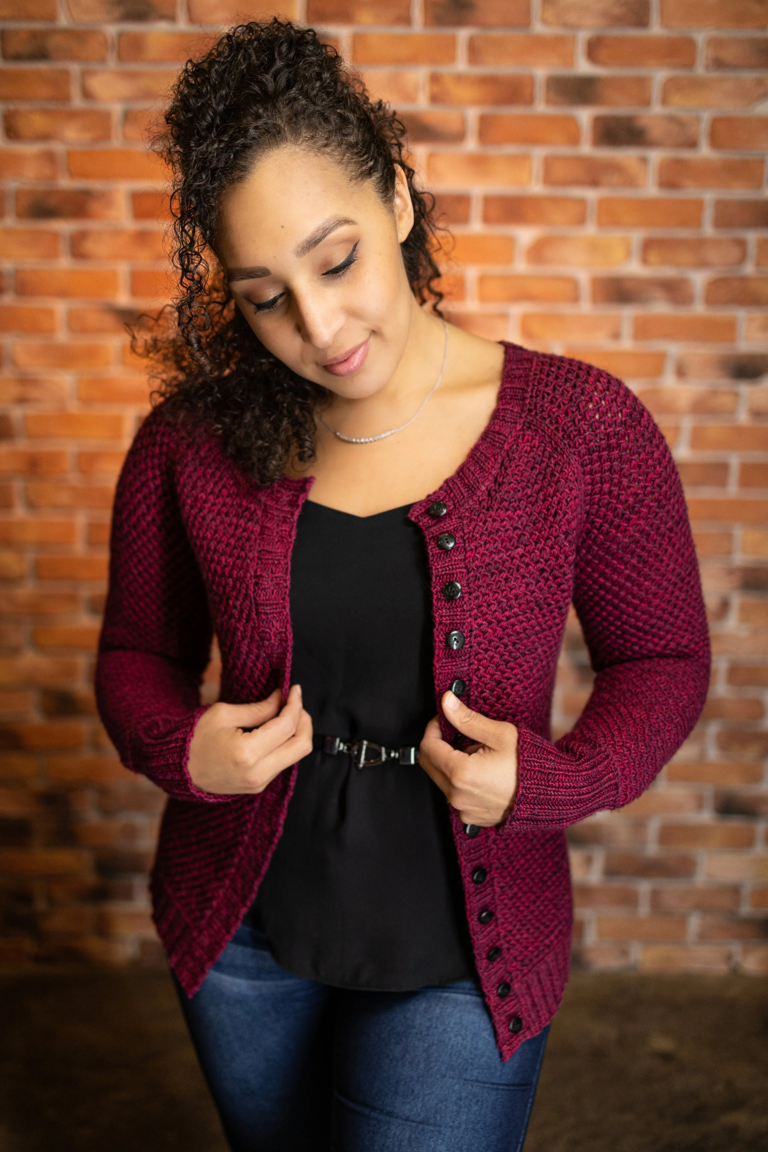 PNW knitwear designer Vanessa Smith (NessaRenee on Ravelry) shows her classic red, full-length Nydia Cardigan styled open over a t-shirt and jeans, showing its versatility as a timeless layering piece