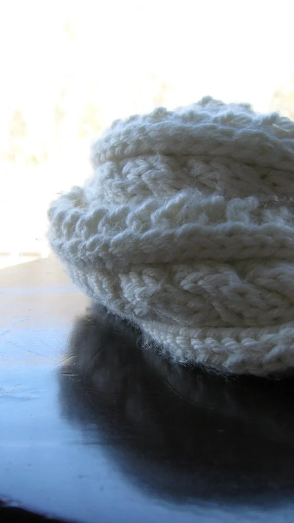 A closeup look at the Cabled Mini Scarf, knit in a luxurious, natural cashmere Aran yarn with large needles. Make your own with this free knitting pattern by Pacific Northwest designer Vanessa Smith.