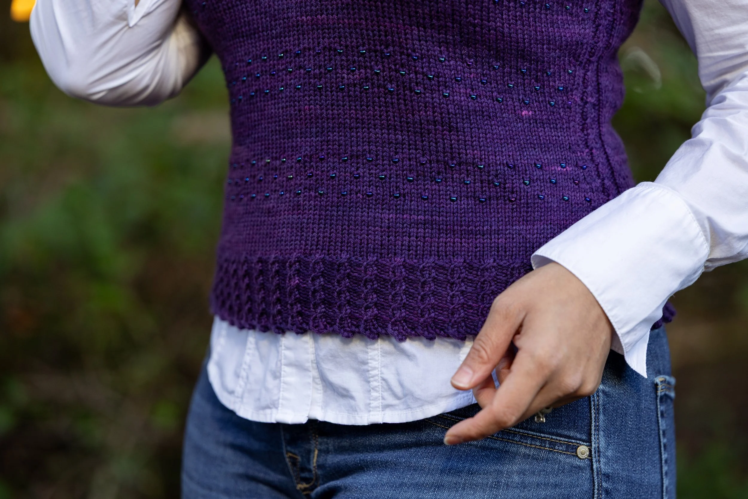 Close look at the intricate yet easy picot/cable cast on edge; mini faux cables; and dotted, textured stripes in Vest Behavior, a size-inclusive slipover featured in the Cast On issue of PURL Magazine