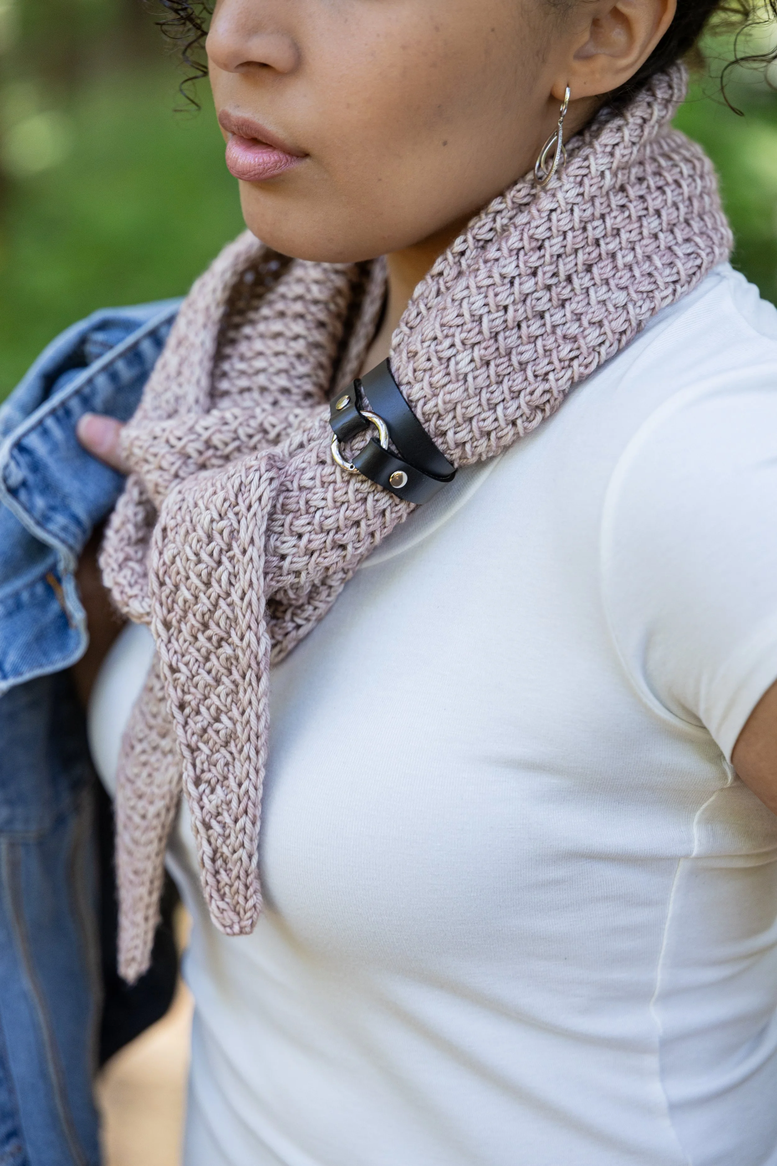 Tipping Point Scarf shown in the small shawl chonky size and styled with a leather shawl cuff. Just two skeins of a worsted/Aran weight yarn create a wonderfully squishy, textured handknit accessory.
