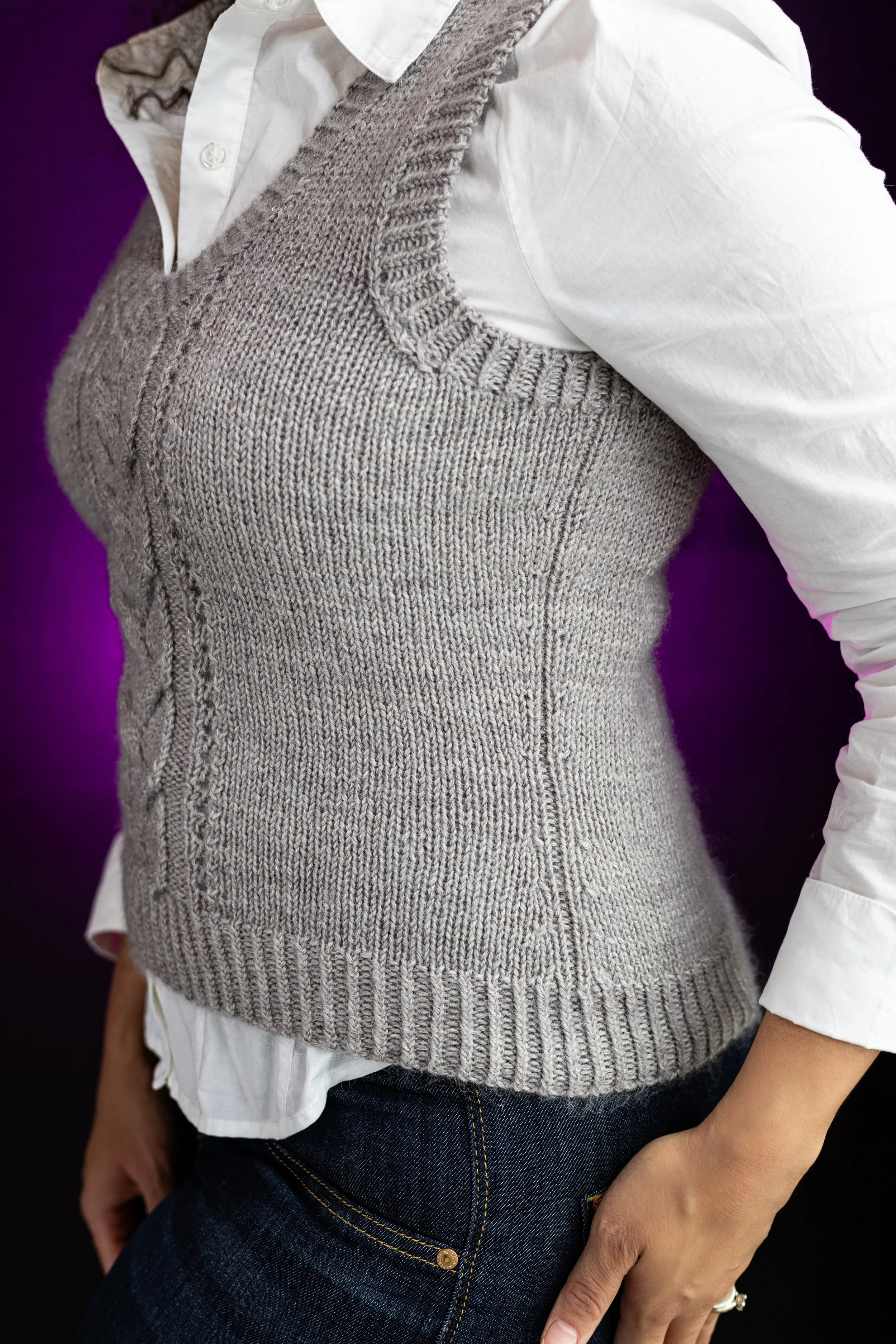Side profile view of the mid-length Bestie Vestie knit vest, highlighting its comfortable fit and layering potential, especially for spring, fall, or office wear. PDF knitting pattern by Vanessa Smith