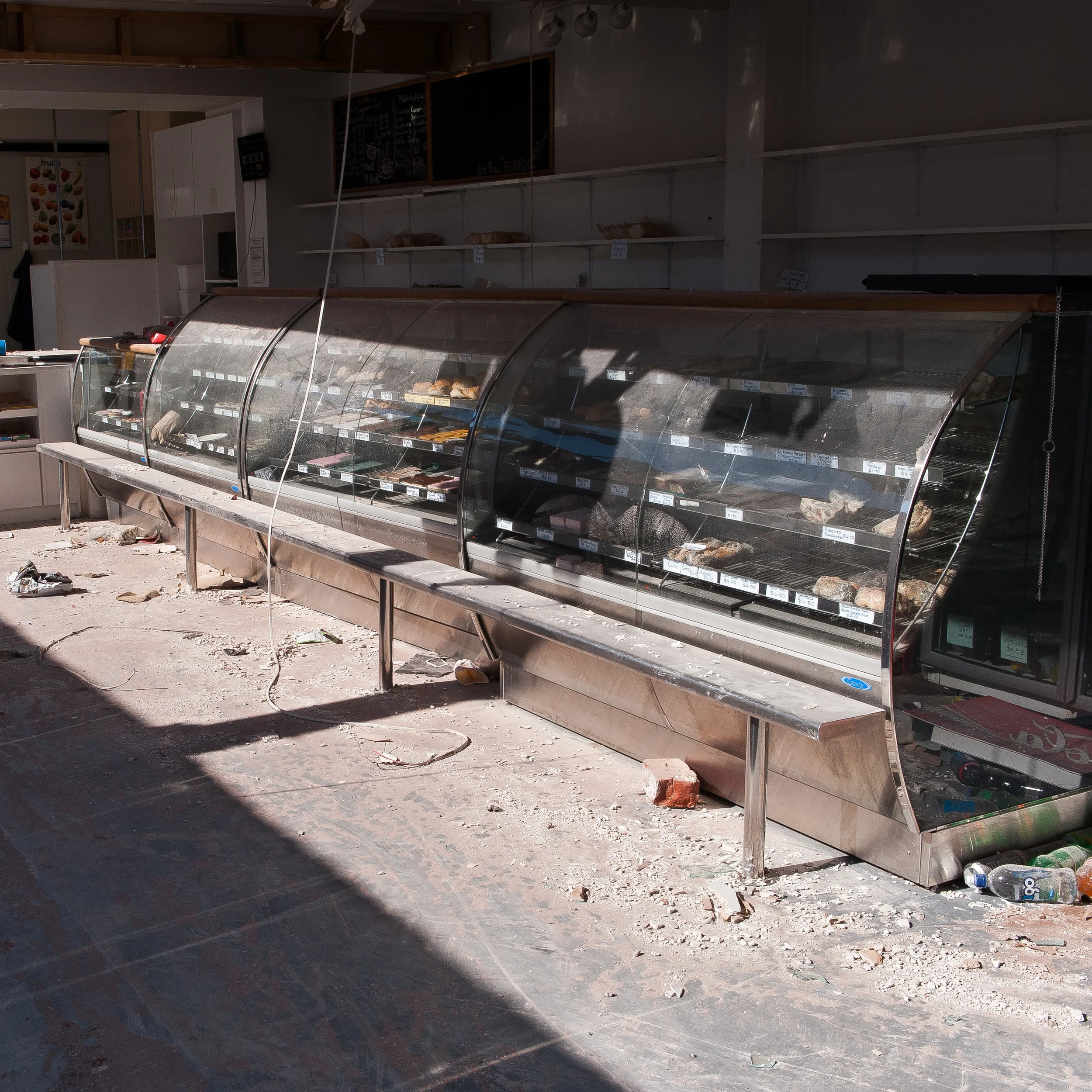A Sydenham Bakery; one person was killed and another paralysed for life when a neighbouring building collapsed onto this store during the February 22nd earthquake. Three months after the event and food was still sitting in the cabinets as it was ready for sale on the day of the earthquake.