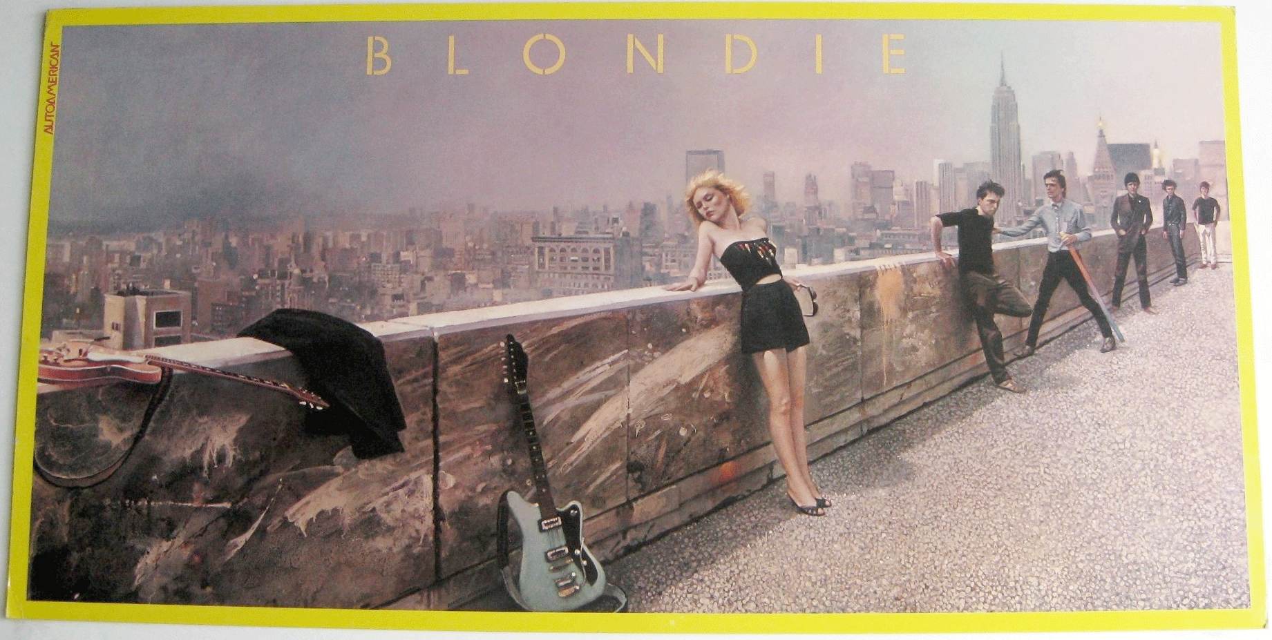 Item #00091 NEAR MINT Original Blondie Record Store Promo for Autoamerican Description: Follow Me? Rapture? The Tide Is High? Are you kidding me? Gotta love it!!!! This is not only a Blondie fan's dream, but an Interior Designer's dream as well. The vibrant colors are sure to brighten up any room. According to Wikipedia, " Autoamerican was released in November, 1980. Besides rock and pop tracks, the band explored a wide range of other musical genres: Here's Looking at You and Faces show jazz and blues influences. The reggae hit, The Tide Is High, was a cover of The Paragon's 1965 Jamaica ska hit, whereas Rapture combined funk, rock, jazz, and even saw them embracing the then budding genre of rap. The closing track, Follow Me, was a cover of a torch song from Alan Jay Lerner and Frederick Loewe's 1960 Broadway musical Camelot , based on the King Arthur legend." Date: 1980 / 1981 Item: Original Vintage Record Store Promo Material: Slick card stock Size: 25" wide x 12.625" high Created by: Chrysalis Records and Tapes Text: Nothing printed! This piece was meant to be displayed and admired. Condition: NEAR MINT! The yellow, black, gray, and a little bit of red iconic image is beautiful and in NEAR MINT condition. One very, very small bend on the bottom left corner and some minute fraying on the other corners make it NEAR MINT and not mint. Debbie looks insanely fabulous! Shipping: Due to the material and size of this item, it can not be rolled or folded.