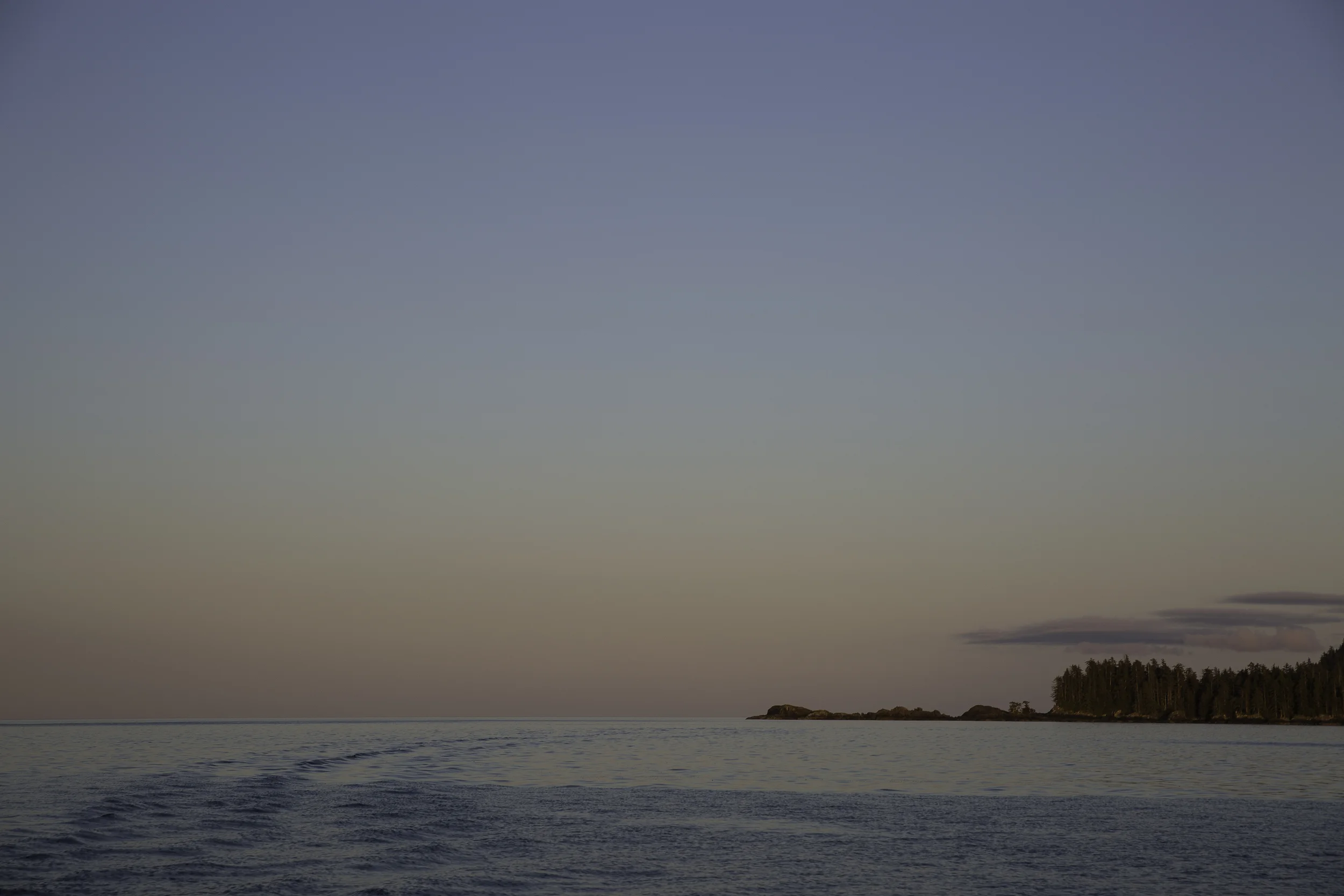 The stern wake fades off into the distance as the sunset turns the lights down and we round into Haida Gwaii.
