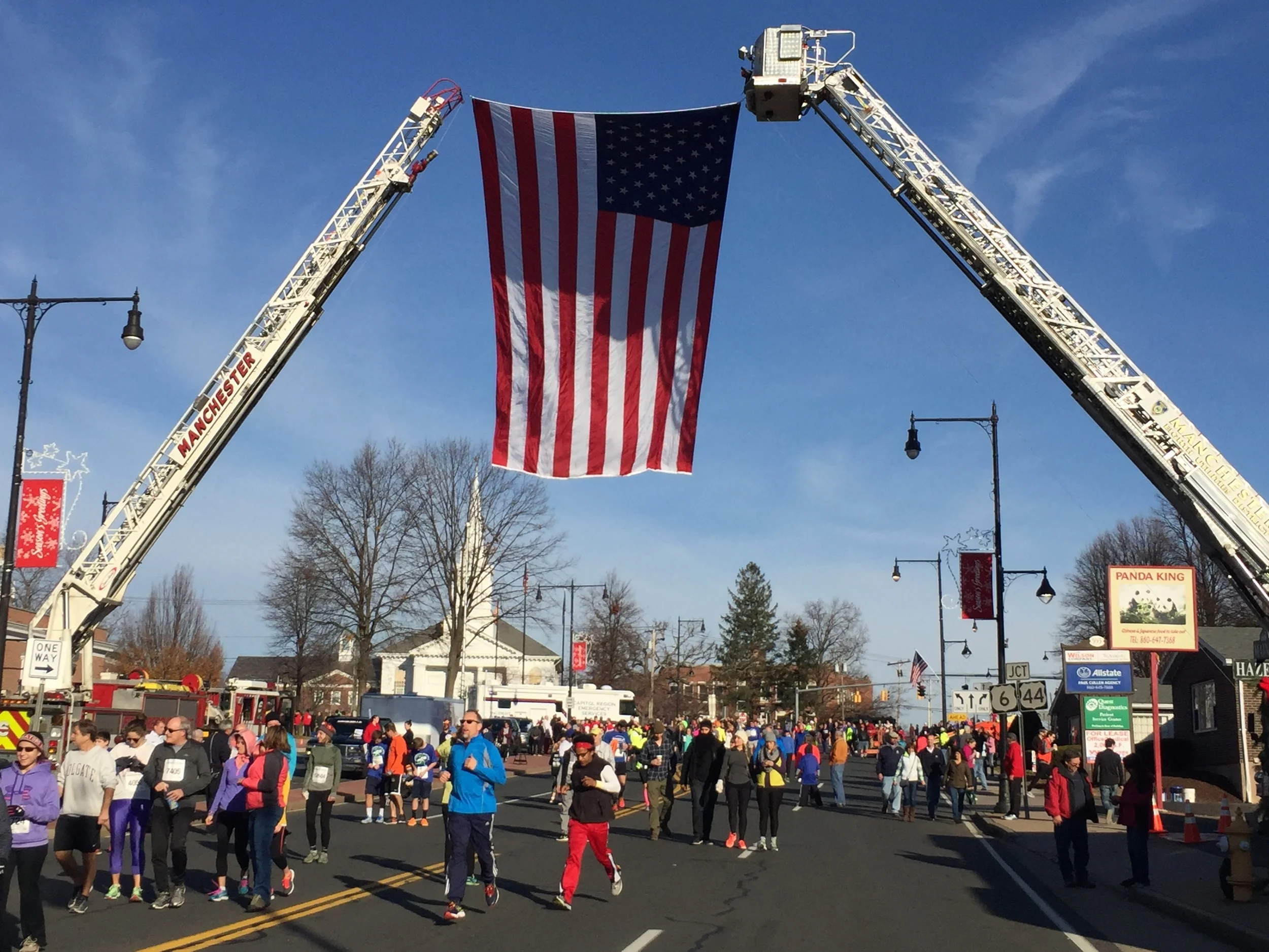 Checking out the race course before the event. This giant American flag flies over runners as they come down Main Street for the home stretch at the end of the race. It's also what the 15,000 runners turn and look to for the national anthem at the b…