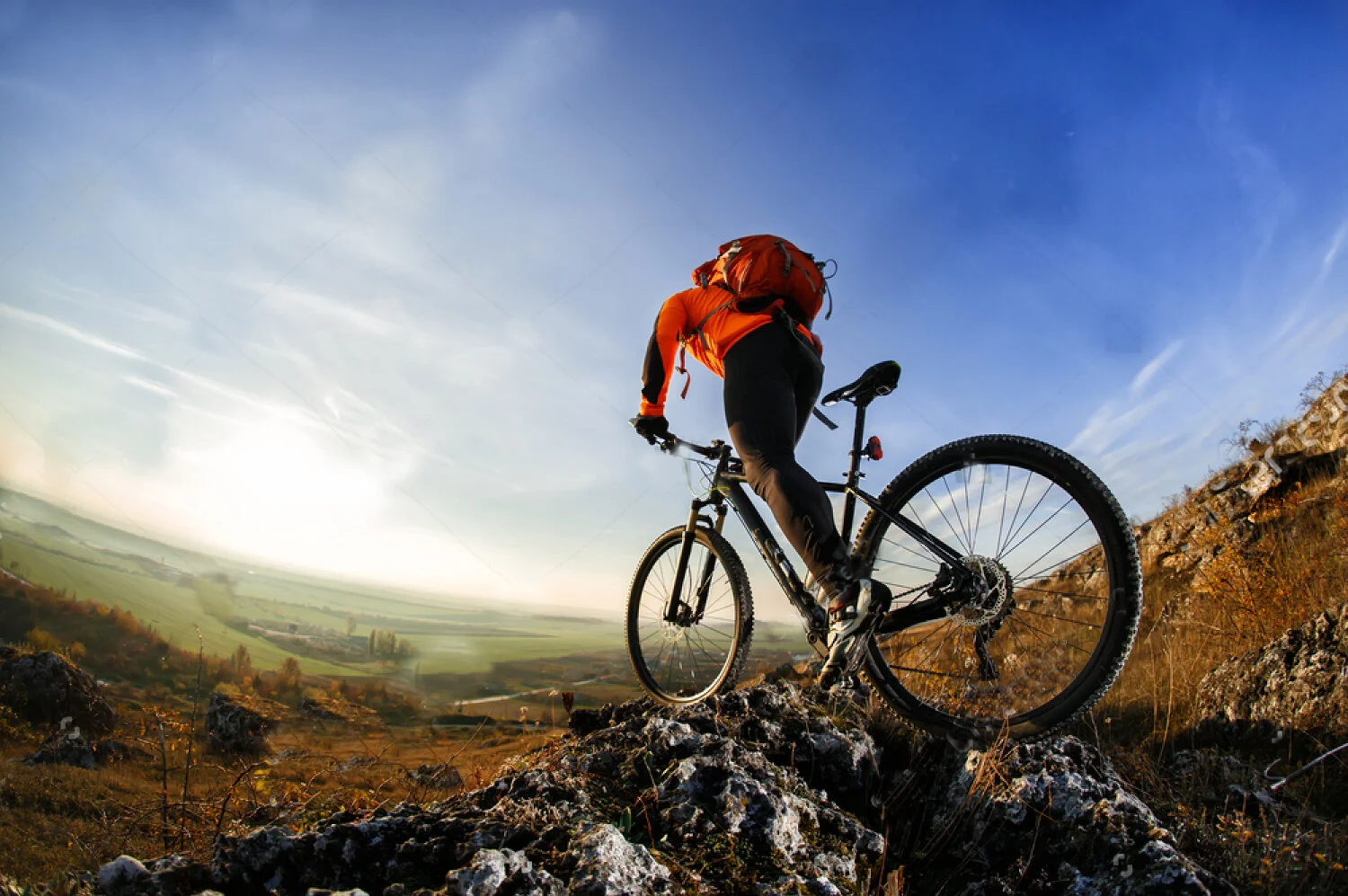 stock-photo-back-view-of-a-man-with-a-bicycle-and-red-backpack-against-the-blue-sky-cyclist-rides-a-bicycle-573940339 CROP TEMP.jpg
