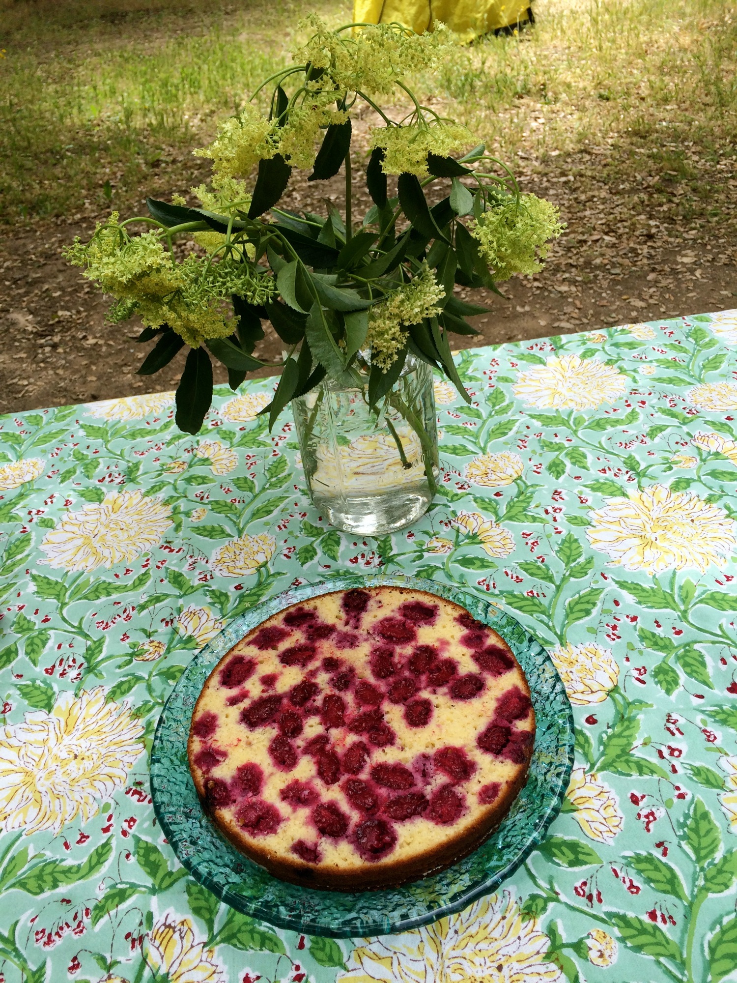 Bottom half of the cake has been drizzled with cordial and is about to be spread with tart whipped cream.