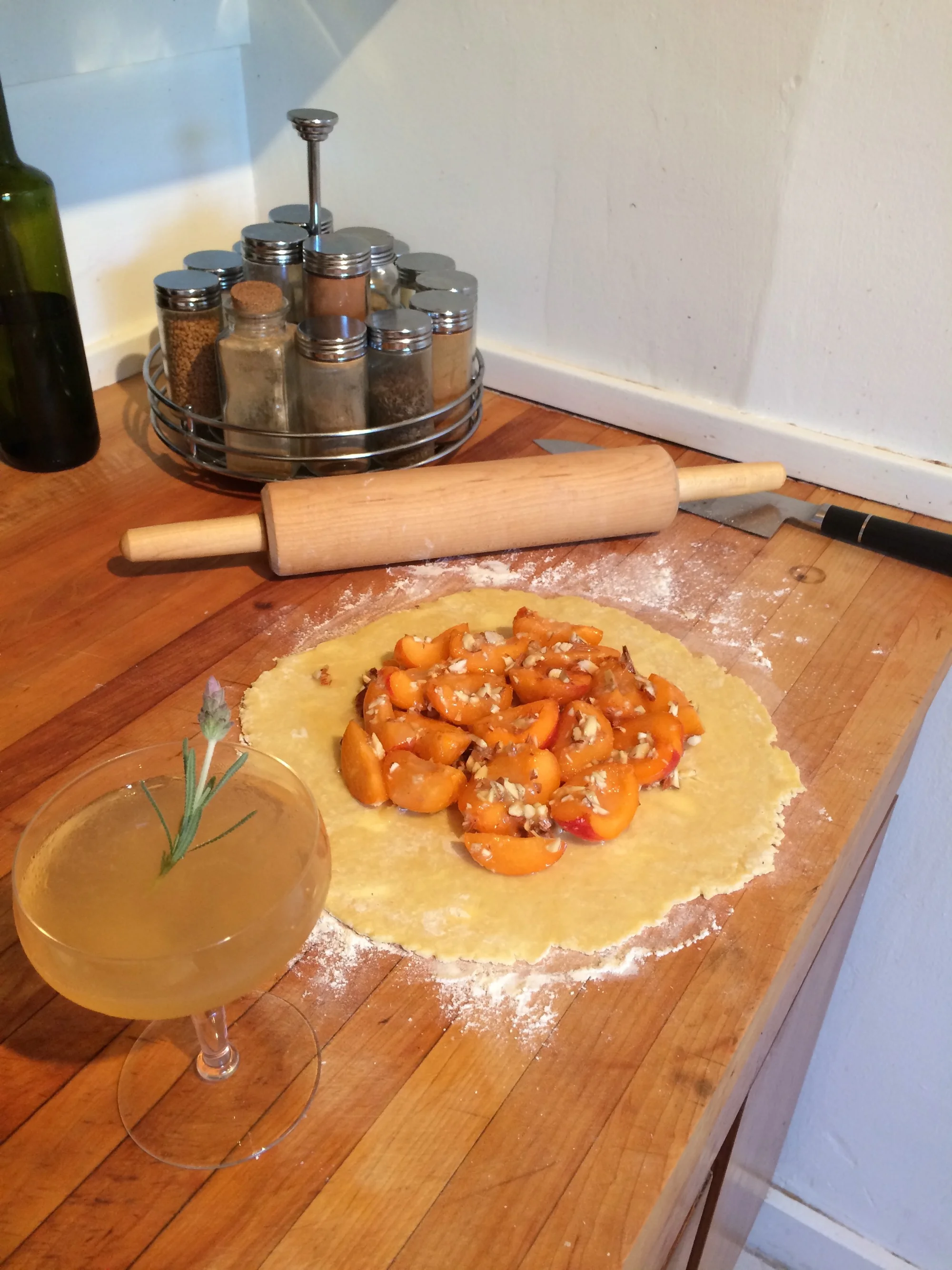 Free form tart shell ready to be folded over filling. Also, a cocktail - rolling out pastry dough can leave you parched!