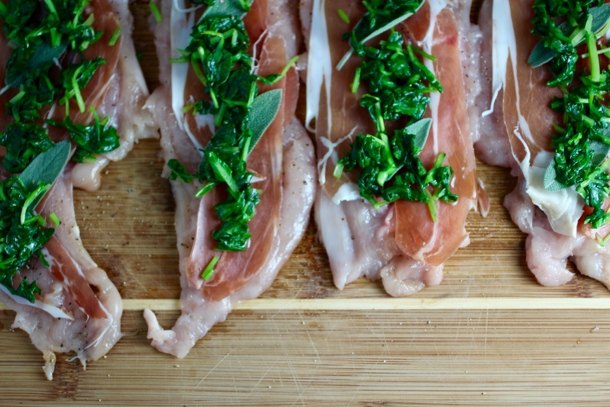 Chicken cutlets layered with prosciutto, sage, and spinach before rolling up.