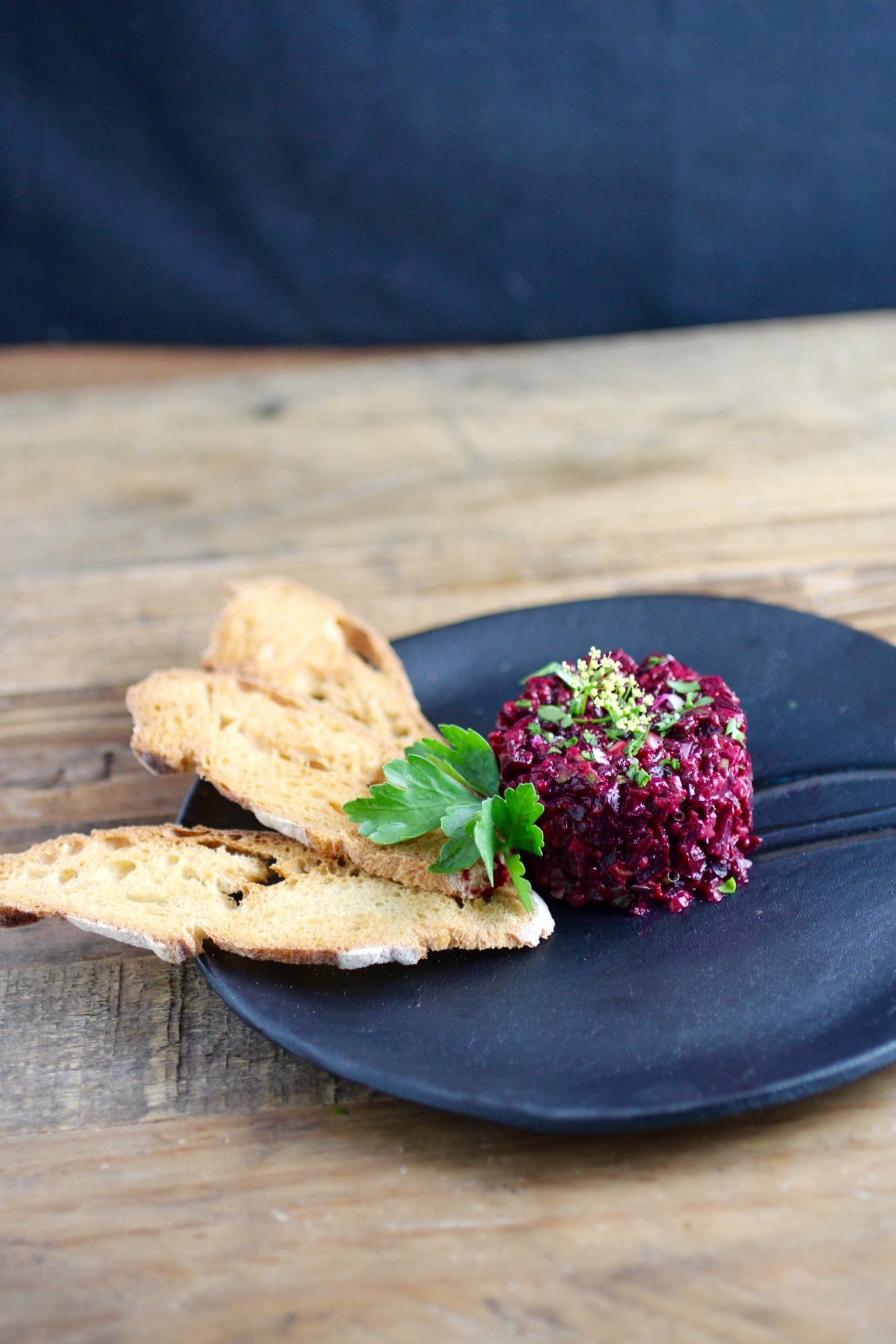 Beet tartare served with baguette crisps, but you can use any edible vehicle for the tartare of your choosing.&nbsp;