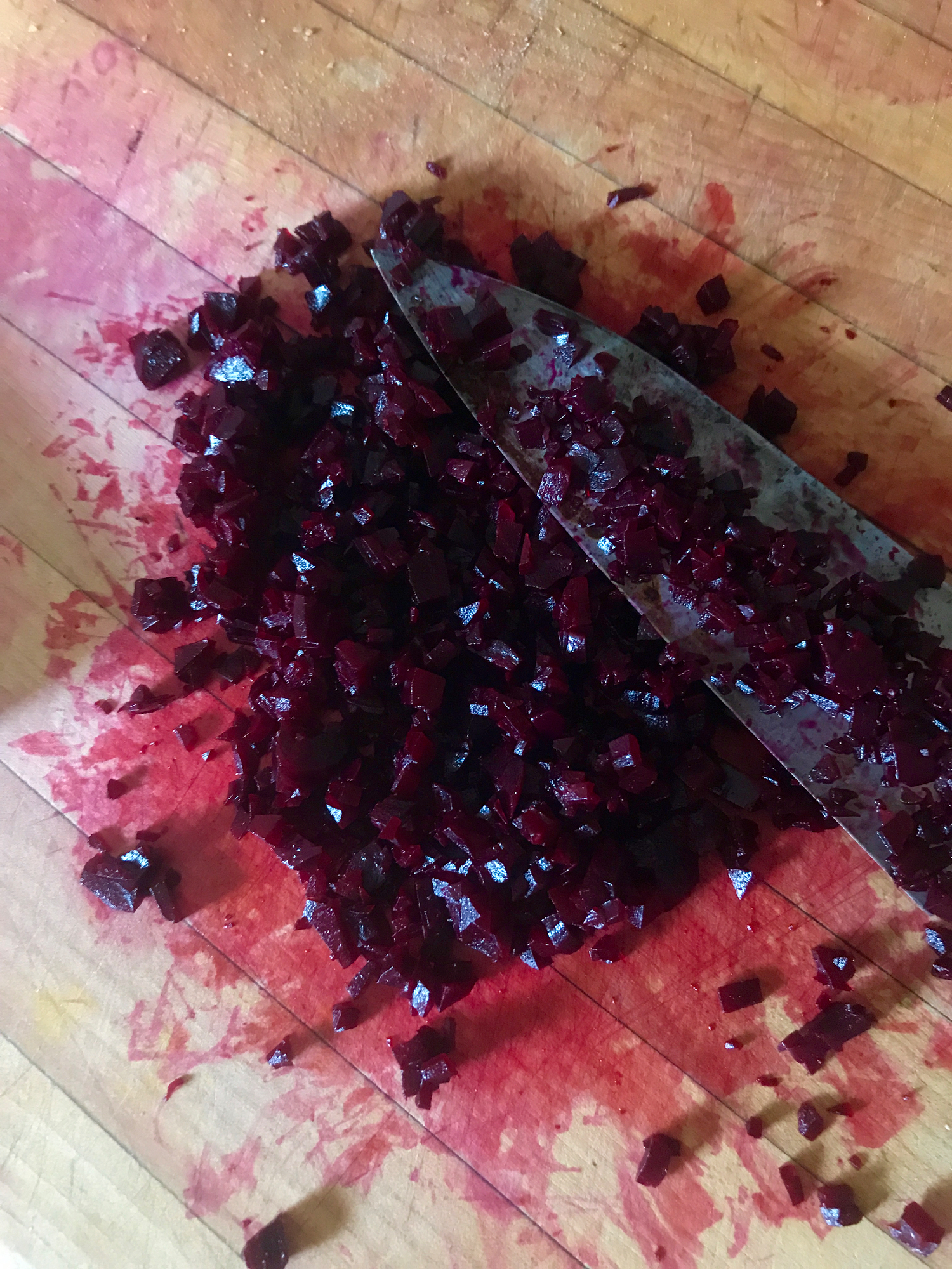 Finely mincing beets - it's not blood, it's beet juice! Be careful, it stains.