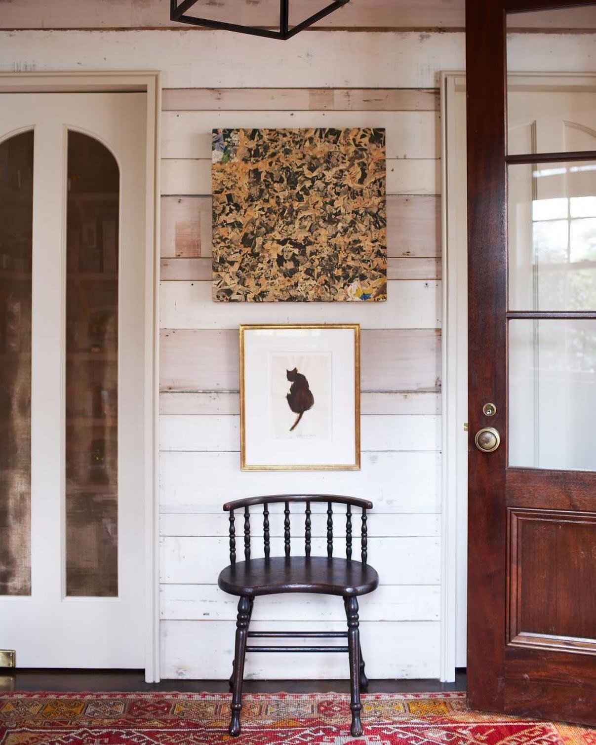 By all appearances this entryway could be original to the home, but it's actually part of the updated additions. To create the effect, we used the home's original wood boards, recovered from demolition, and added custom doors and a paneled coat close