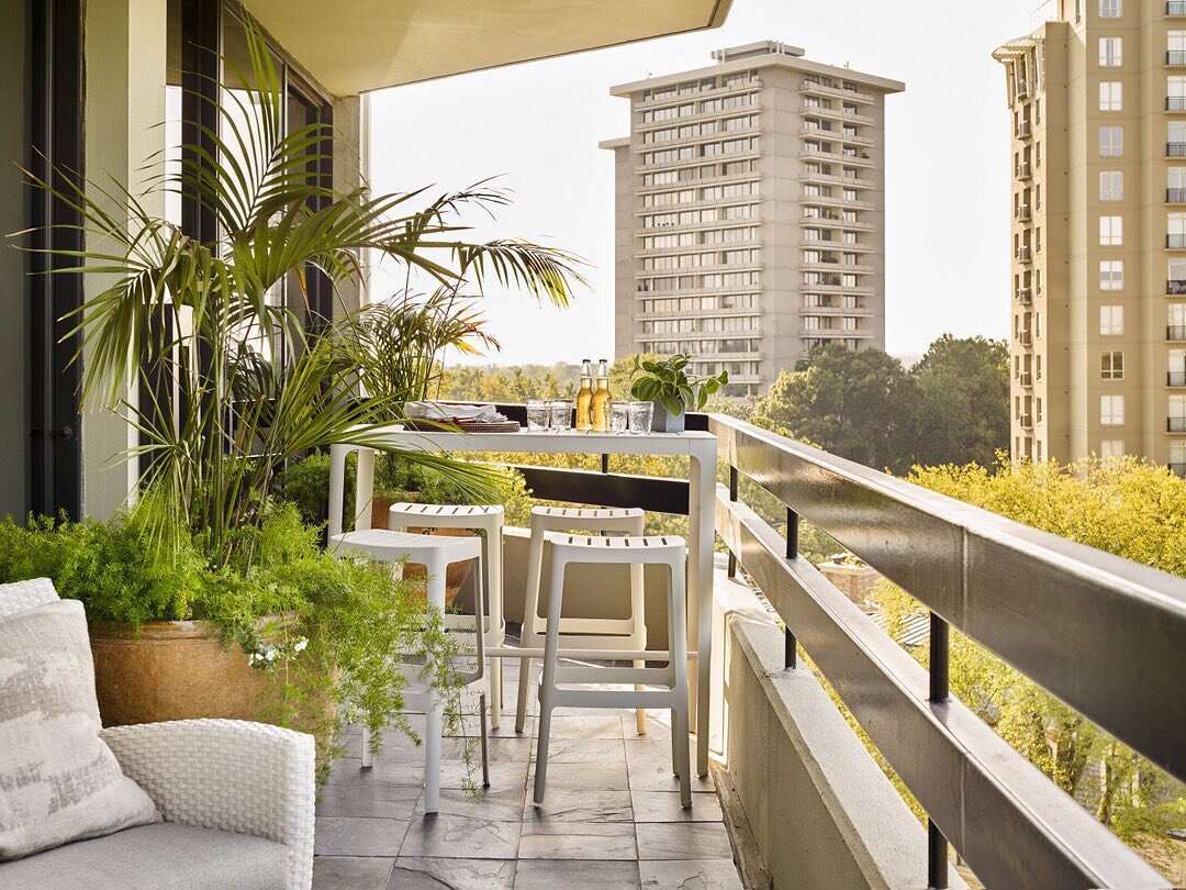 Urban Oasis?! ✨ We emphasized this sunny view with a chic @kolocollection bar height table as to maximize this golden view. Enjoying a sunset, while not required, is highly encouraged.  #CKI #CarterKayInteriors &bull; 📸: @emilyfollowillphotographer