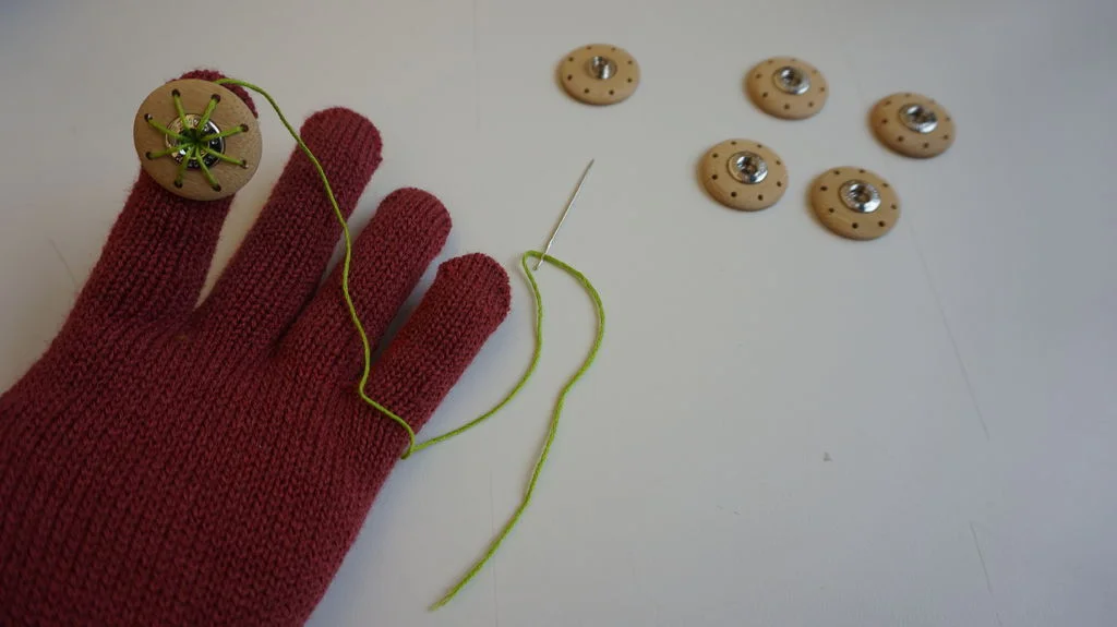 Step 2: Sewing buttons on each finger.