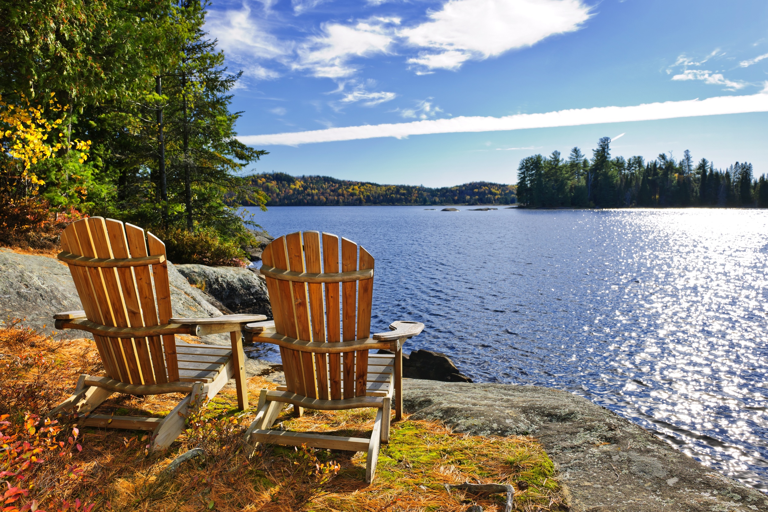  image of two chairs sitting by the waterfront 