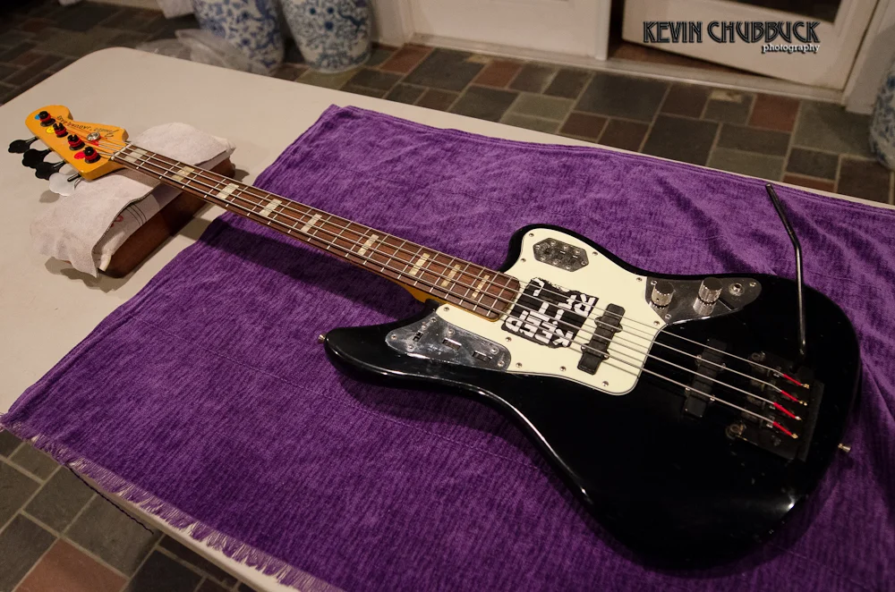 Chuck’s bass repairs finished, note the white pick guard under the black duct tape!
