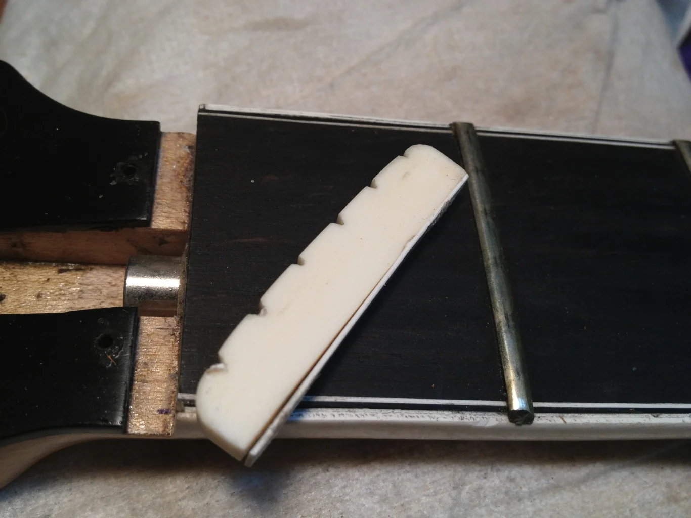 Original nut removed. Note the shim on bottom.