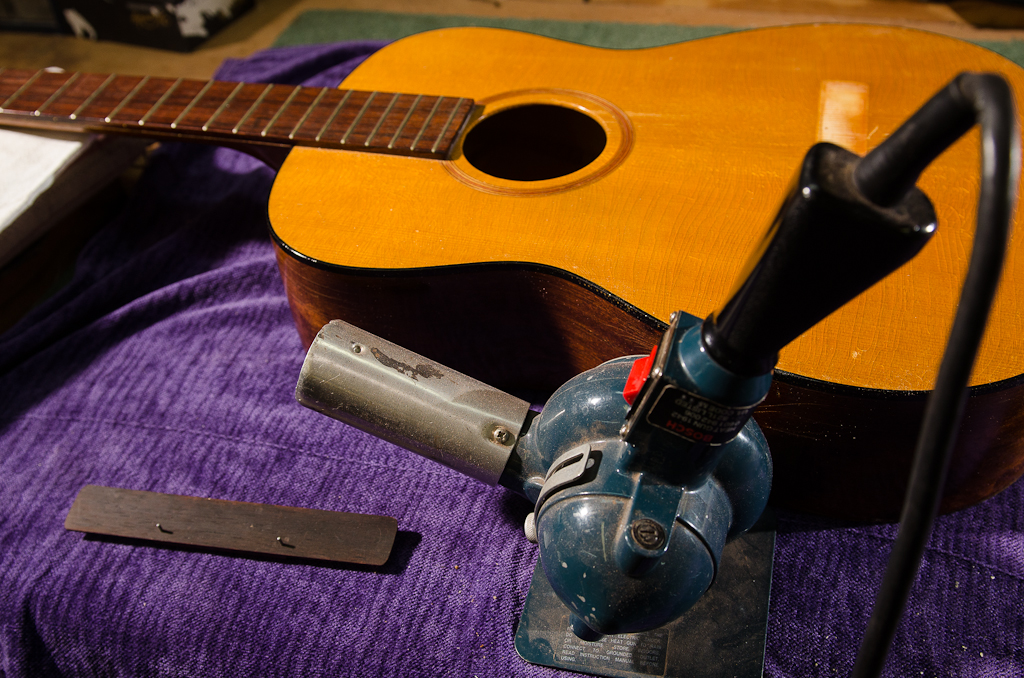 Heat gun is used to warm up the bridge and soundboard footprint to extend hot hide glue working time