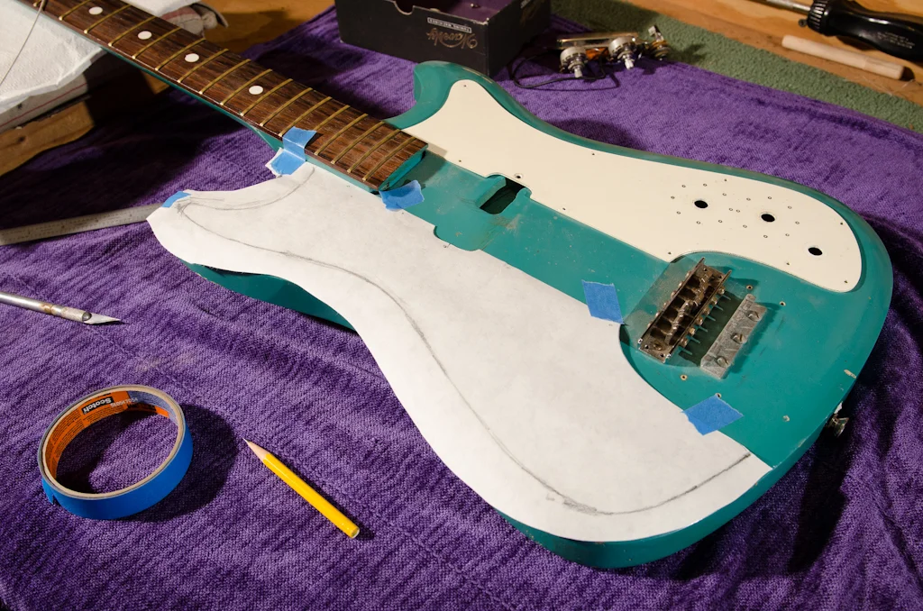 Now for the other side: the new control guard. The body is asymmetric, so the new “lefty” guard has to be cut and shaped by hand. I used the pickup side of the original guard to layout the inside of the new lefty guard.