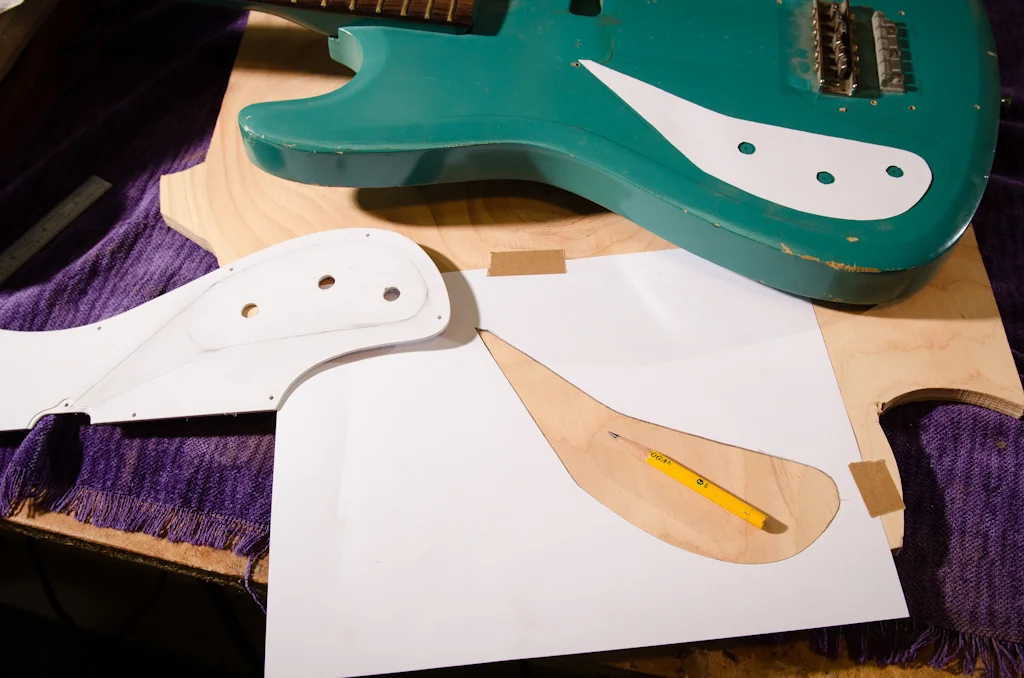 The photocopy is cut out and used to layout both the cavity location on the body, and the routing template made of scrap plywood. I use the control mounting holes in the new lefty guard to “center” the routing template location using my control hole marks on the body.