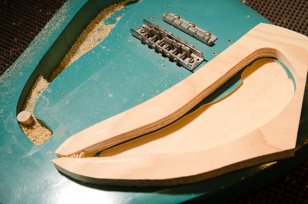 Originally I thought I was going to use a thicker piece of plywood for this template. This plywood was too short to allow the router base clear the bridge, so I had to remove the hardware. No biggie.