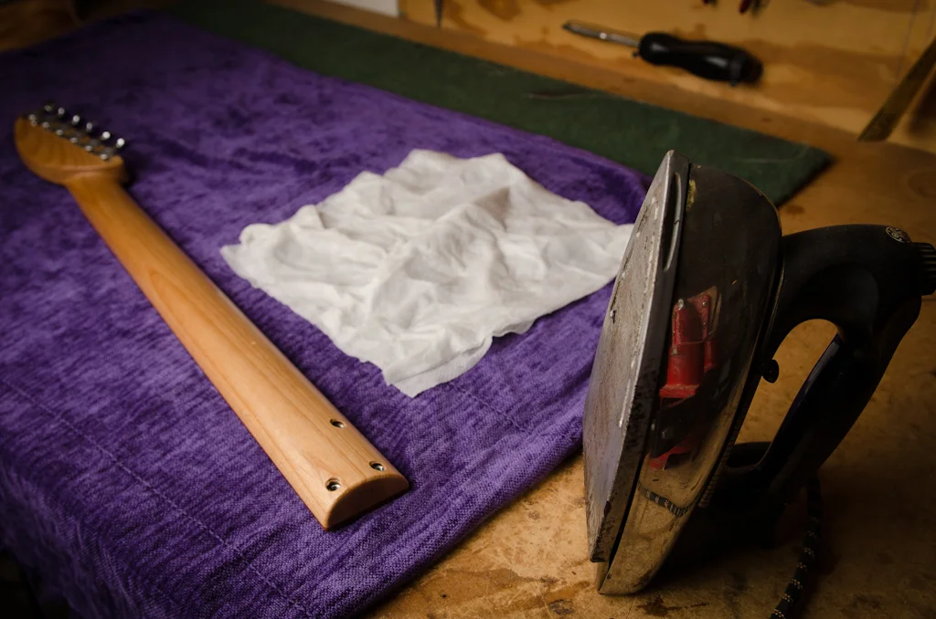 A Wypall dampened with water and heated with a clothes iron steams out most of the damage to the neck.