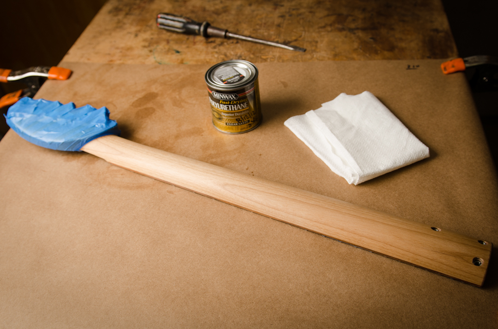The headstock is masked off and a couple thin layers of matte polyurethane is wiped on