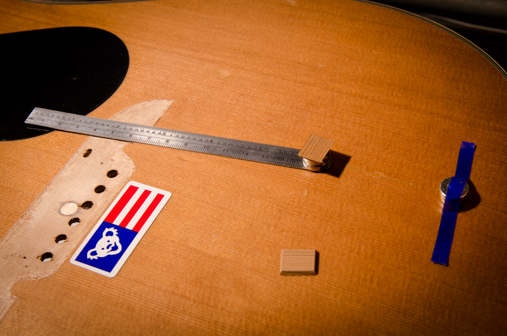 The cleats are double-stick taped to the magnets and a steel ruler is used to install the cleat through the soundhole. Just make sure you get your magnet polarities correct or the cleat will flip over and not glue to the top.