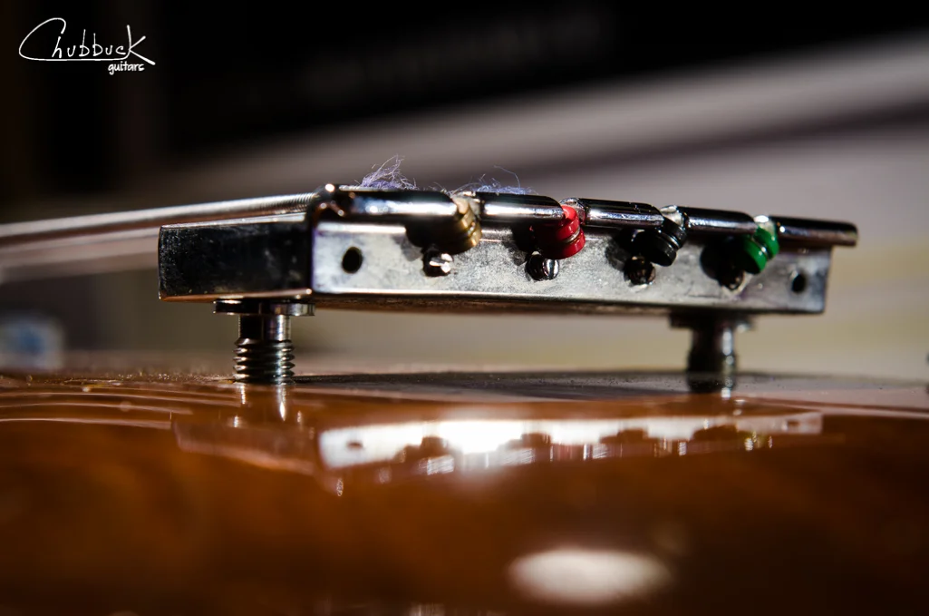 Just below the string ball ends is the saddle intonation adjustments.
