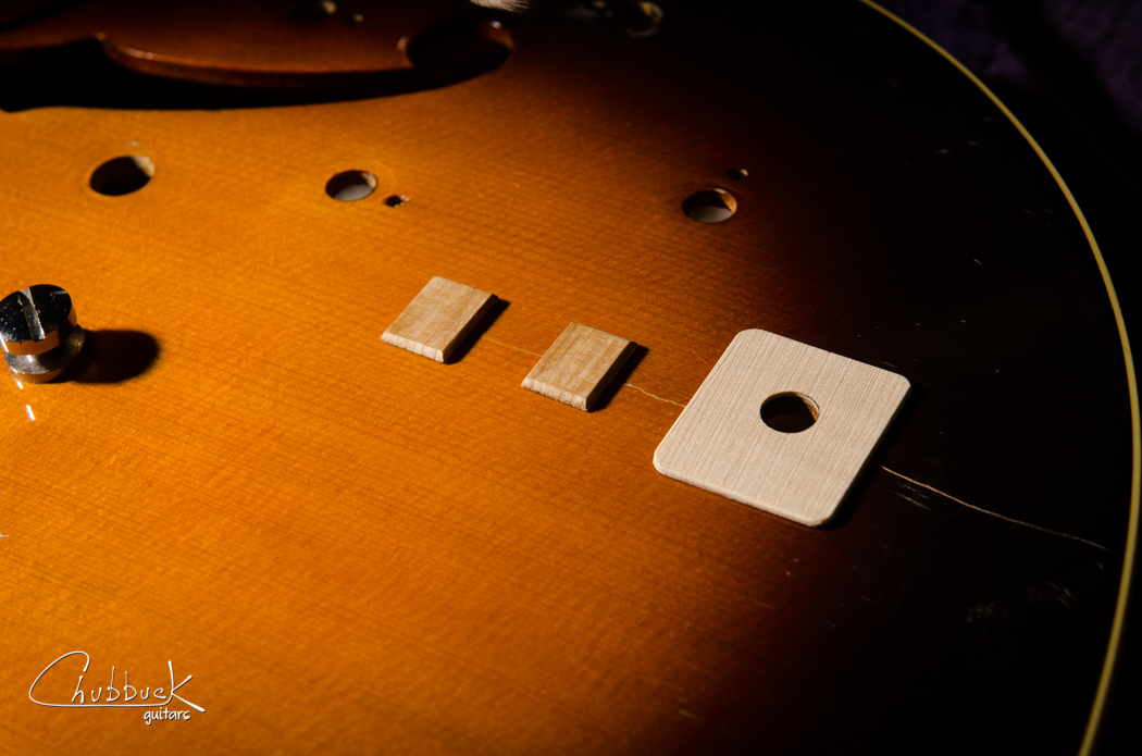 Now that the crack is glued, it needs to be reinforced. The larger jack reinforcement is made of maple while the smaller cleats are made from spruce. Note that I later decided to add a third spruce cleat between the output jack and the edge.