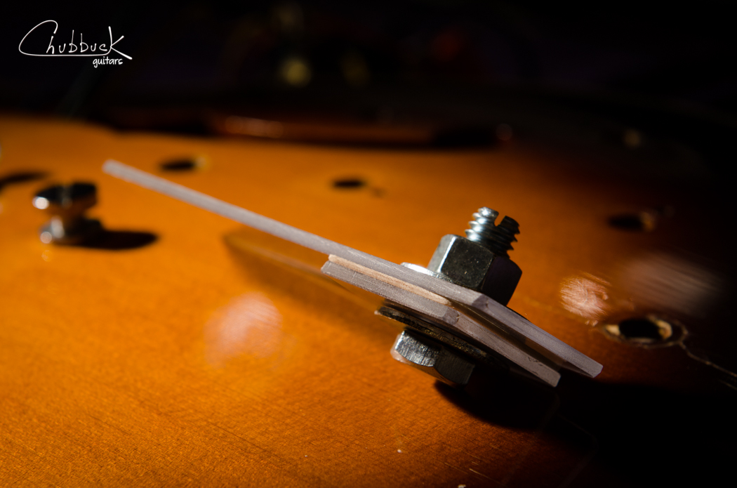 Here is the rig assembled. Note that I made a small mark on the maple reinforcement so that I could easily index it into the correct orientation when it came time to install (bass side versus treble side, perpendicular to the top grain).
