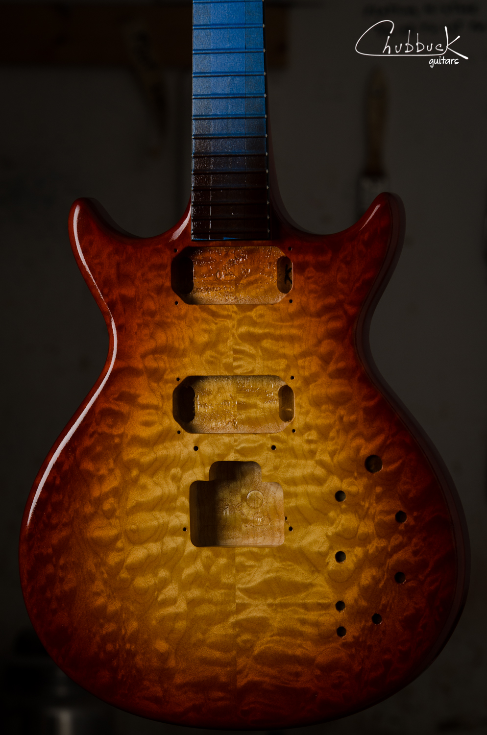 The customer wanted to add a little character with a transparent cherry sunburst. Color layers are applied and ready to begin sealing in with clear lacquer.