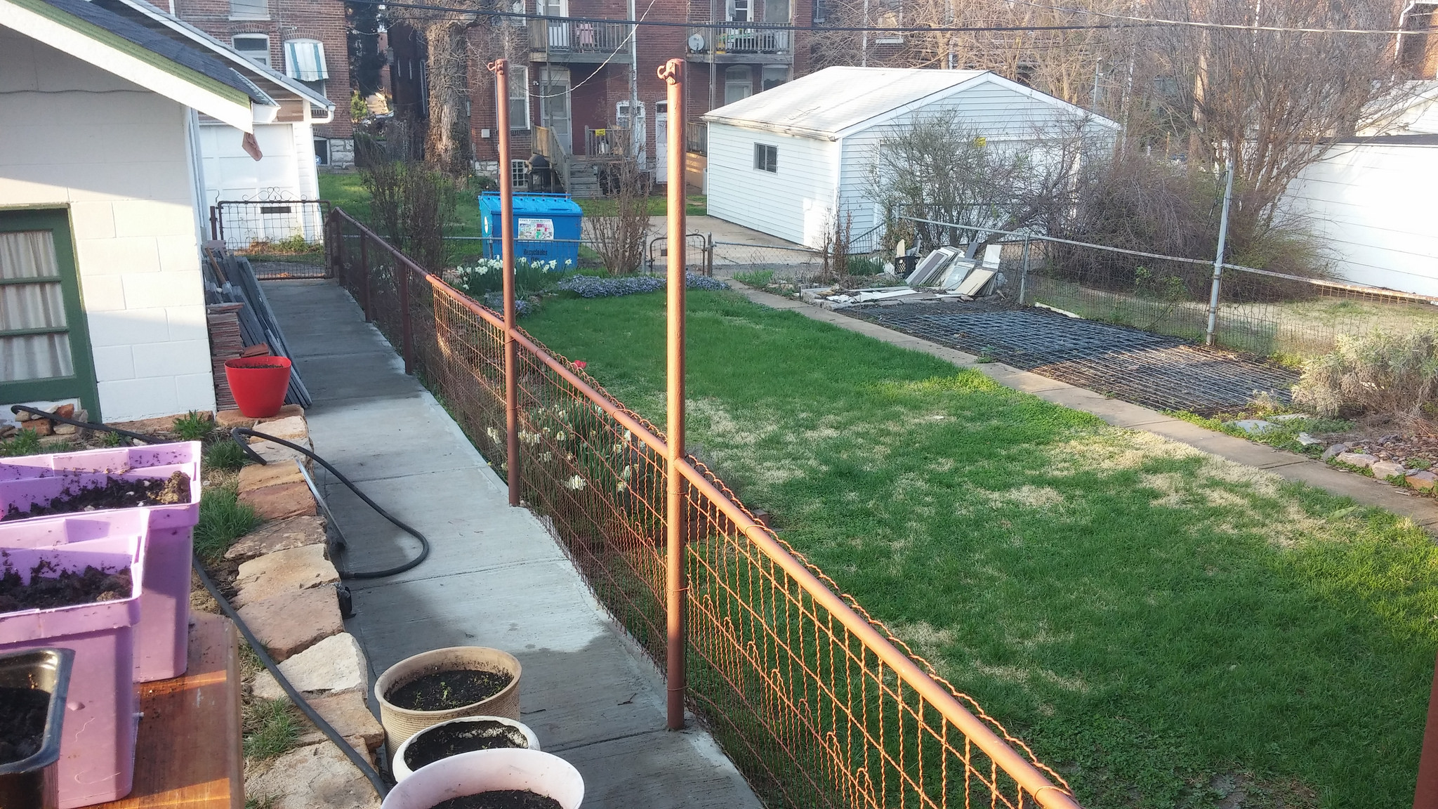 Don't leave your fence brown or you will hear from your neighbors and anyone else who sees it like this. You'll notice our neighbor's normal, silver fence in the background. Soon ours will be normal, too. 