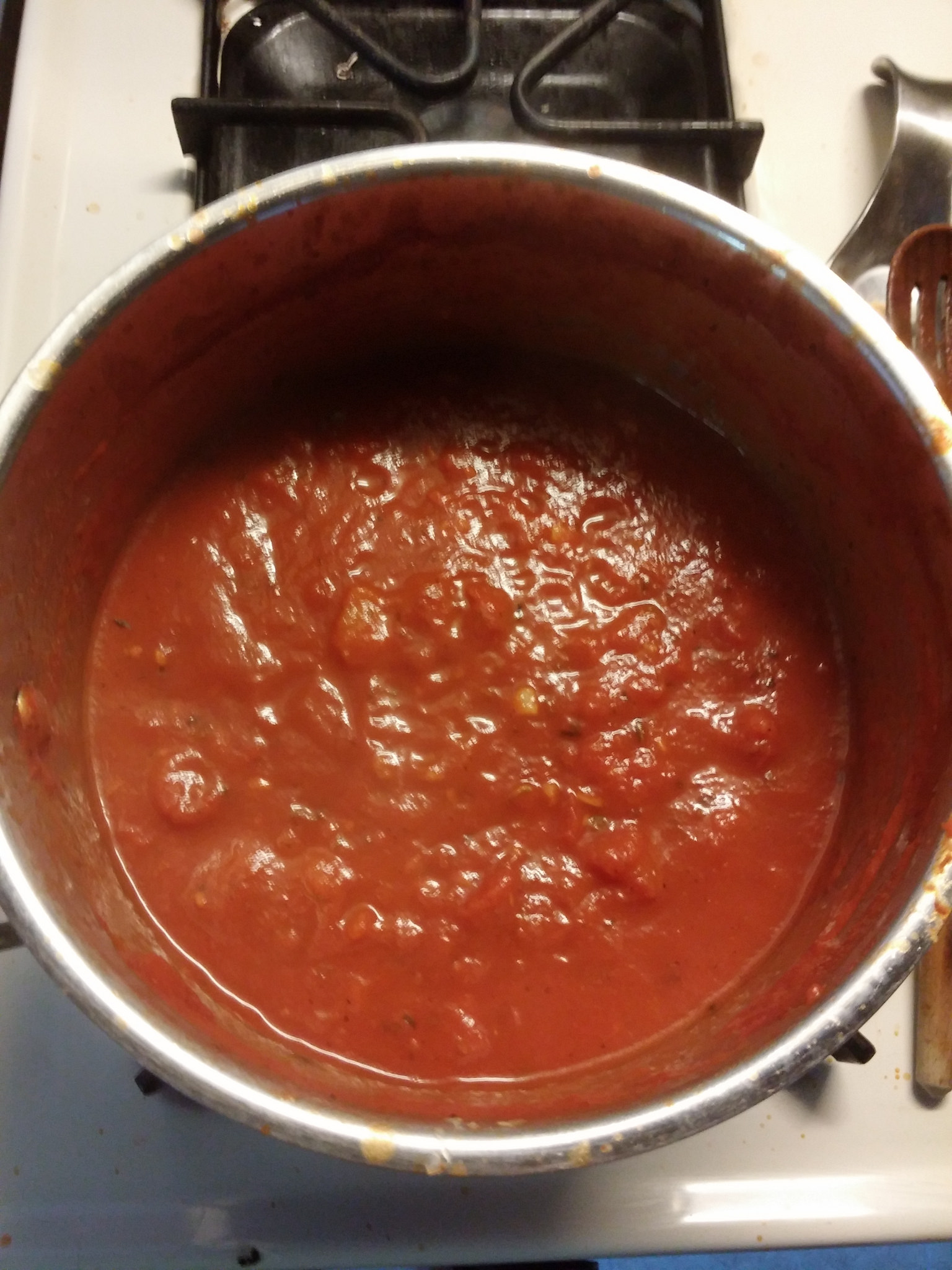 Pizza sauce simmering on the stove. 