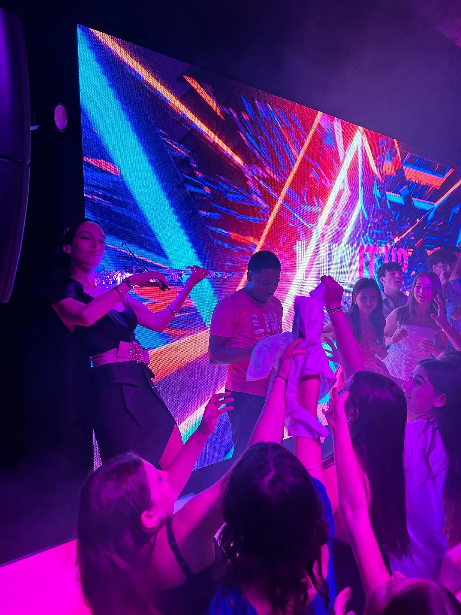 Electric violinist at bar mitzvah playing along with the DJ