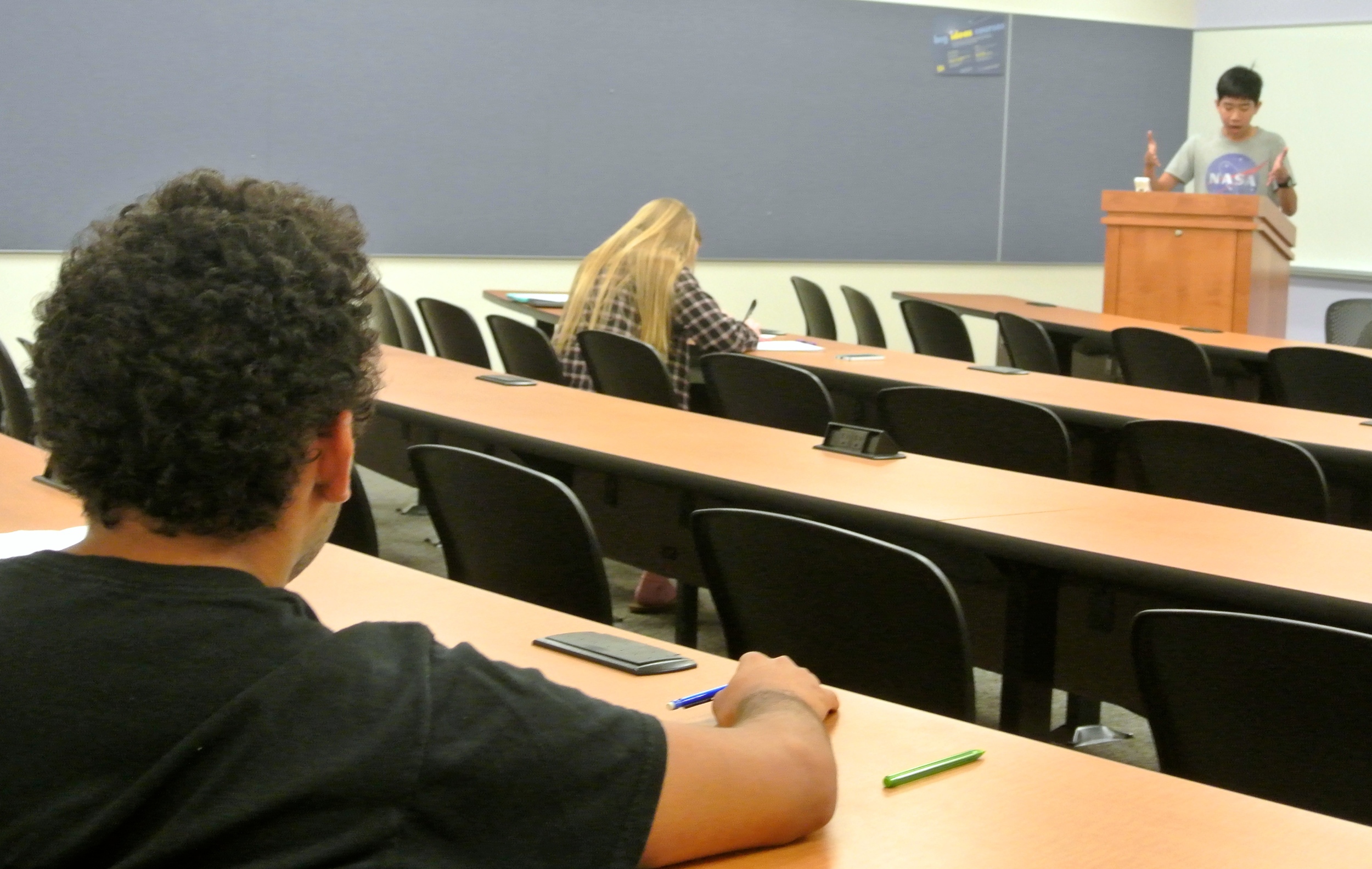 Thomas Liao delivers a constructive during prelims. Partner Mackenzie Mills flows as judge Marco Zepeda looks on.
