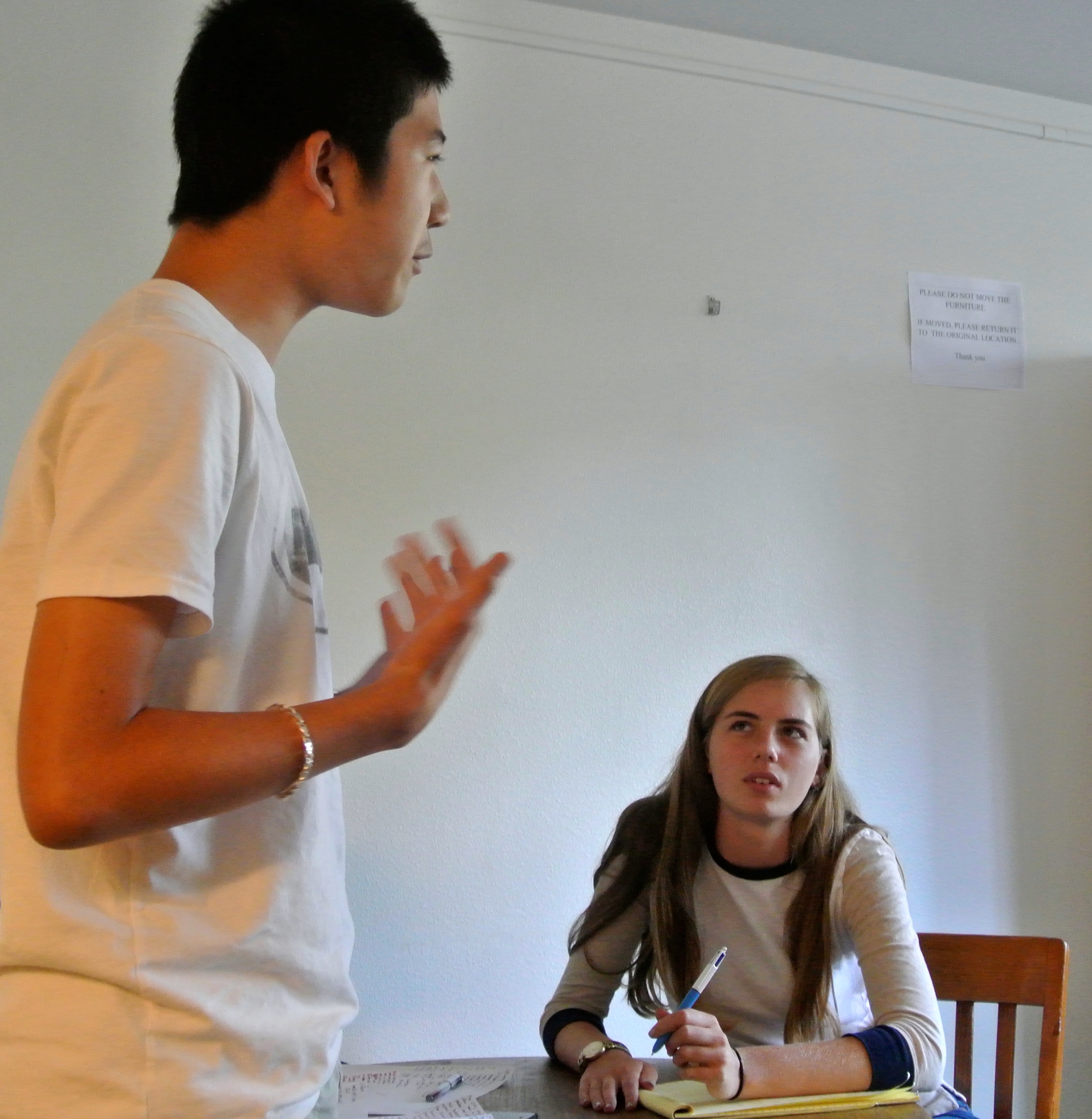 Dougherty Valley's Edward Yu debates as judge Nadia Perl looks on.