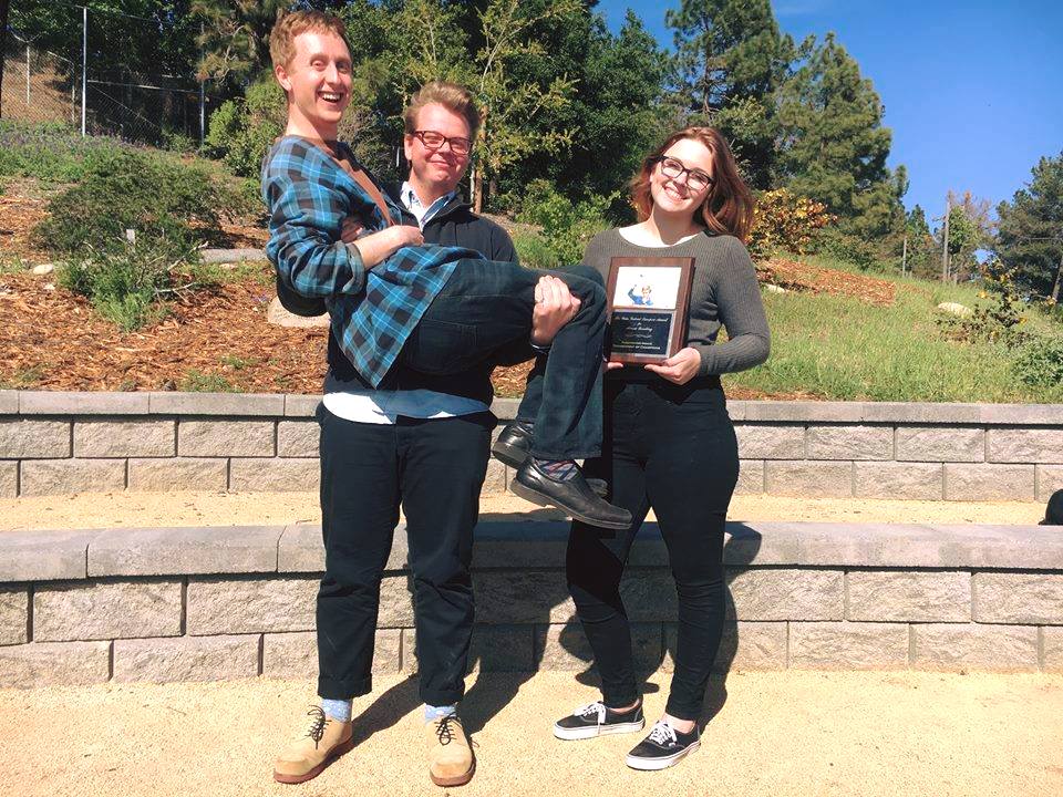 Chad Gasman and Kate Farwell pose with their coach and the eponymous award.