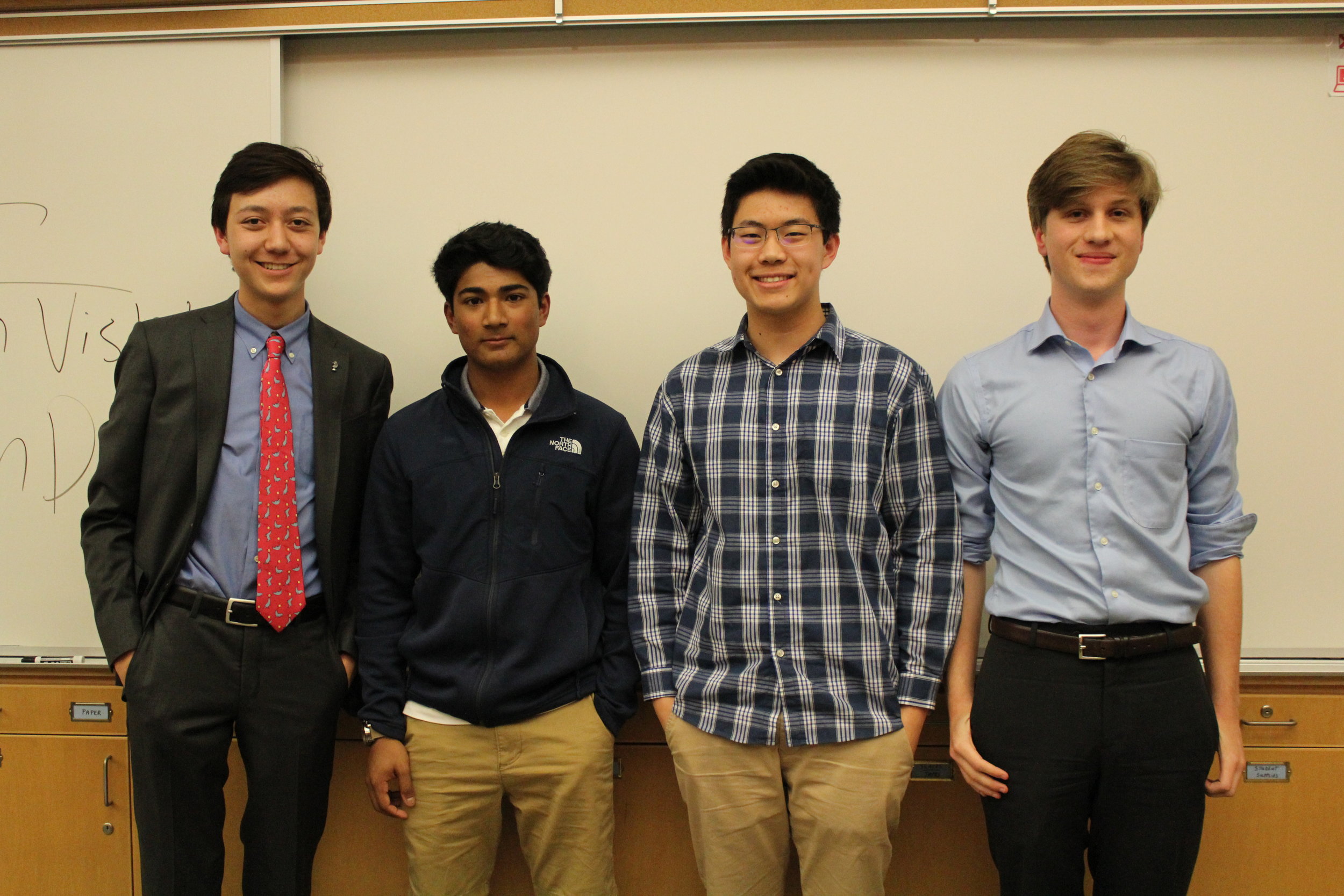 (from left) Kai Burgmann, Krish Visht, Kevin Deng, and Cole McCann-Phillips pose after debating in the final round.
