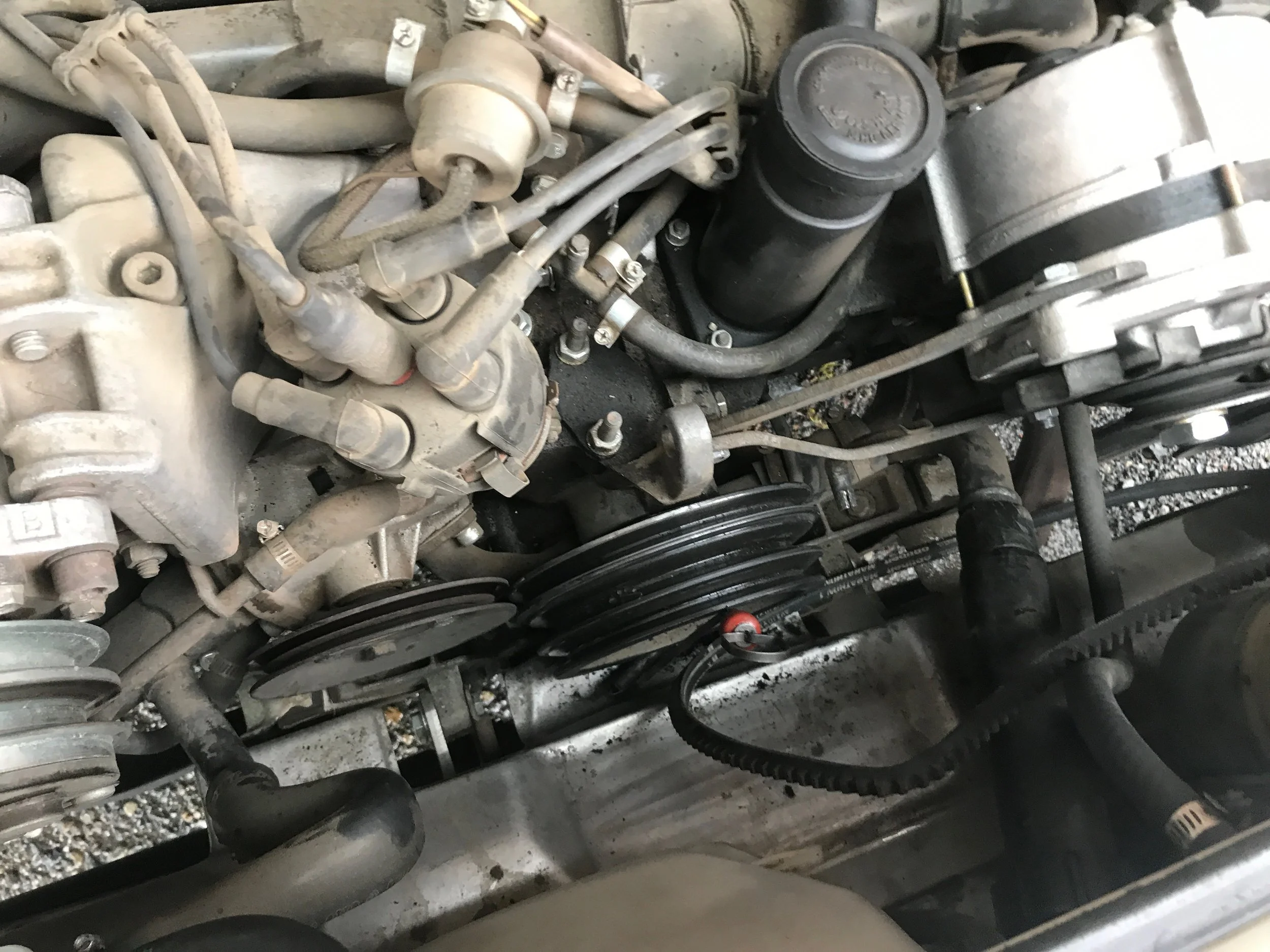 Notice the missing belts on the engine. What you can’t see if the broken alternator bracket under the alternator (upper right).
