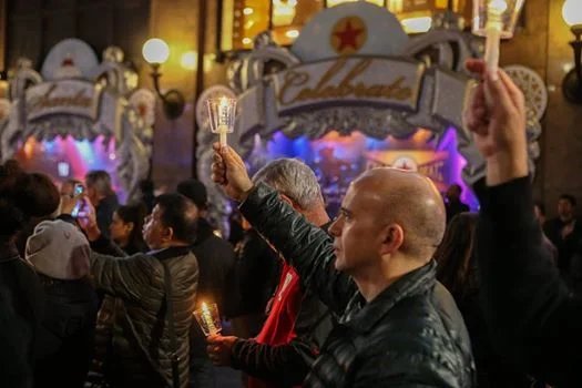 Candlelight vigil in Herald Square before the Sleep Out. Those are the Macy's window displays in the background.