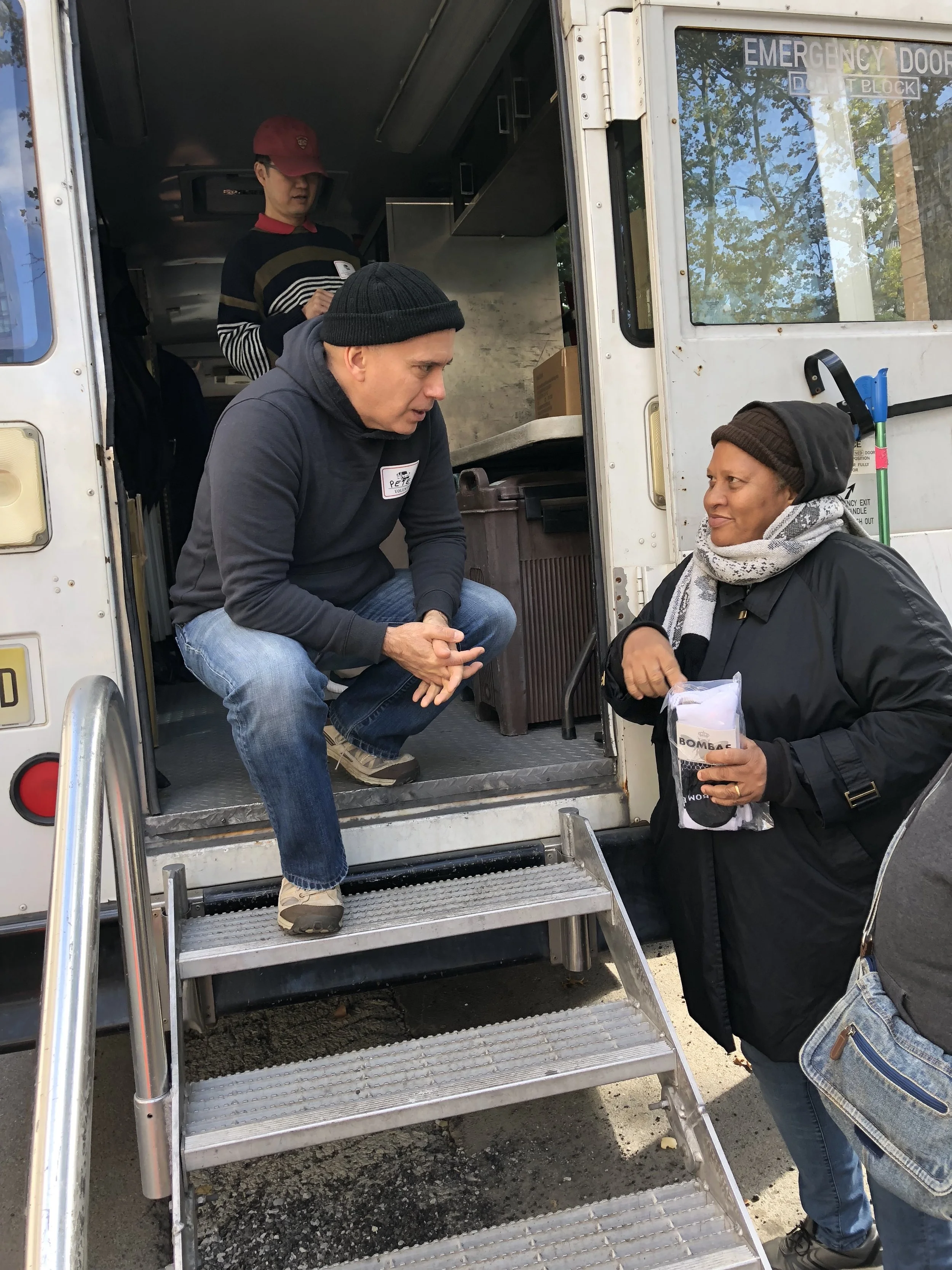 Handing out socks, hygiene kits, and offering prayer