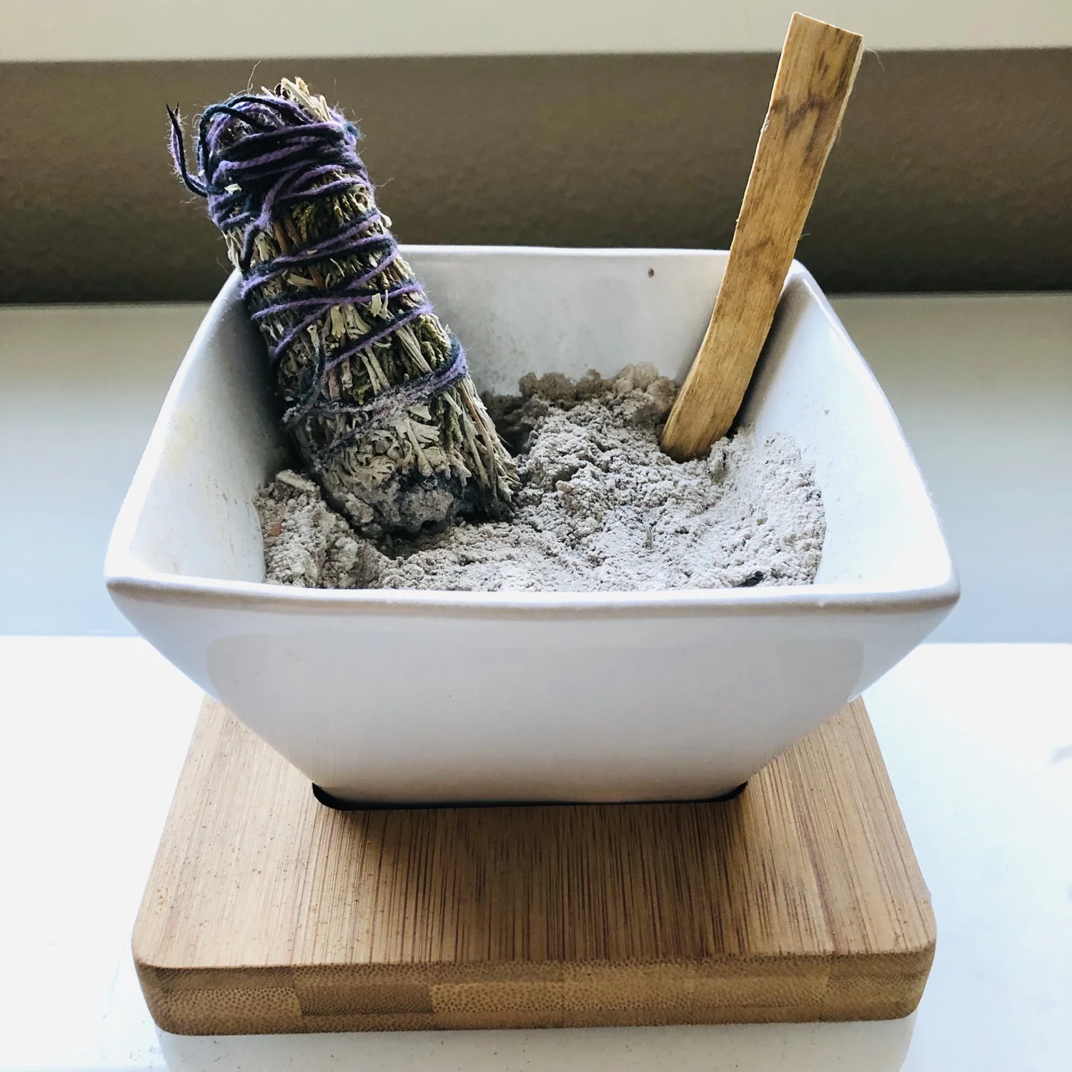 white sage bundle with a stick of palo santo