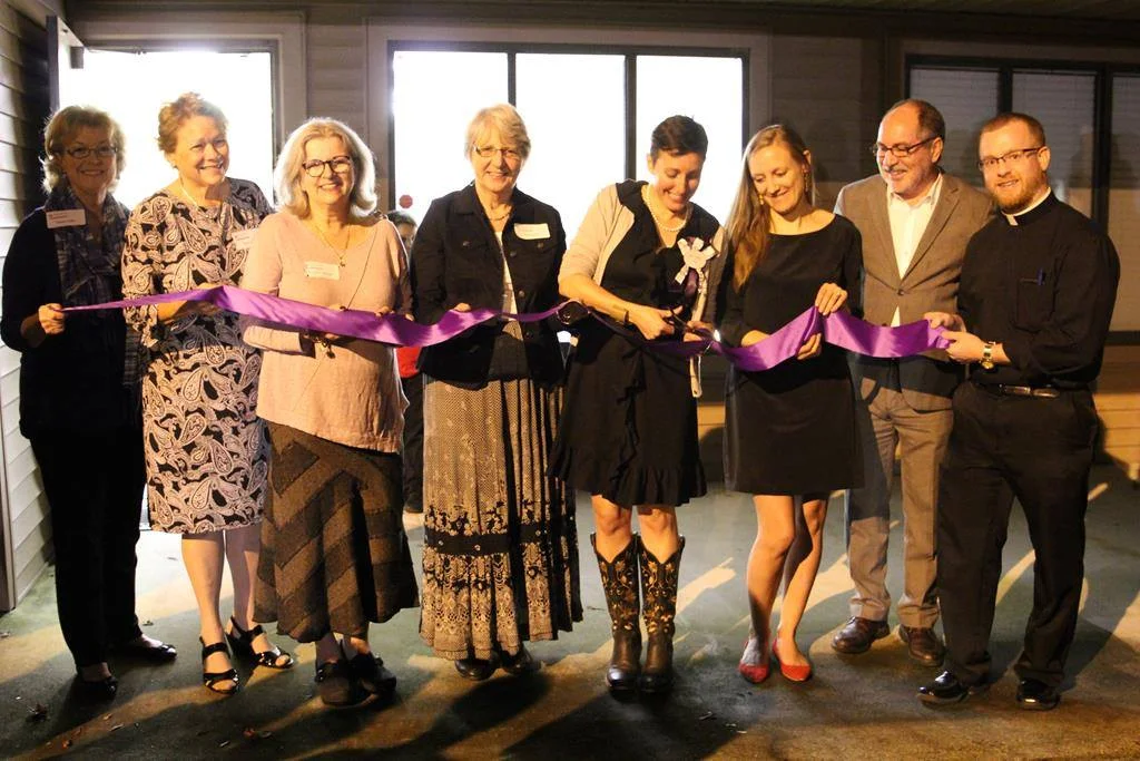 Joined by center staff,&nbsp;local clergy, and Stanton Healthcare representatives,&nbsp;Brice Griffin (center) cuts the ribbon marking the grand opening of Stanton Charlotte Center for Women.&nbsp;