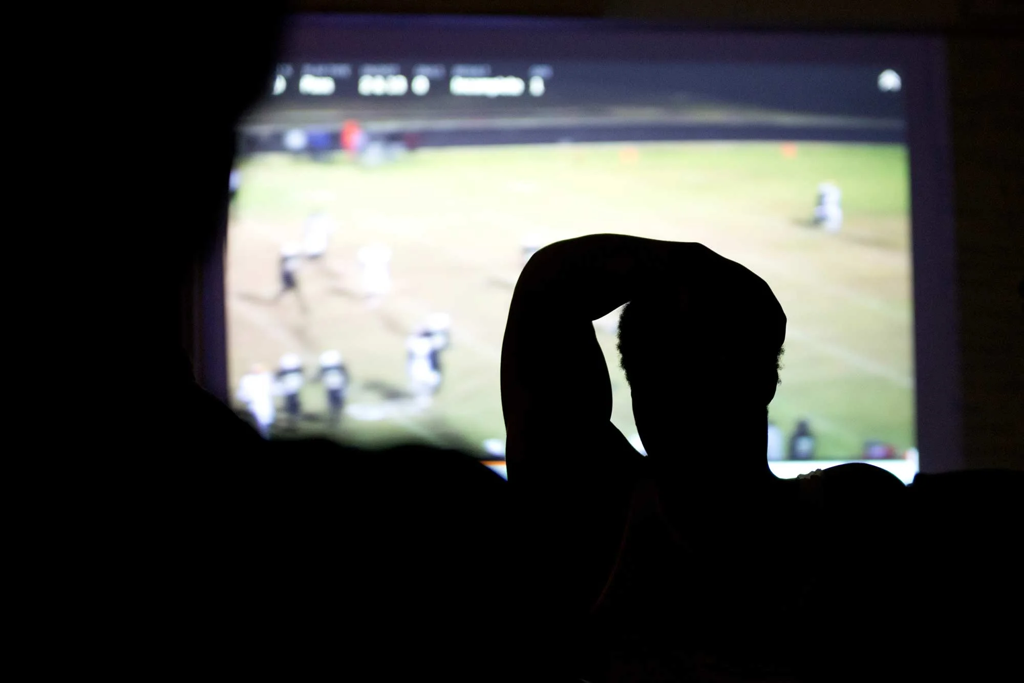 Sophomore Dontae Edwards listens to Coach Antonio King critique last week's game during a Monday afternoon film study session. Edwards, a starting tight end on the squad, is one of the few underclassmen to make this year's varsity team.