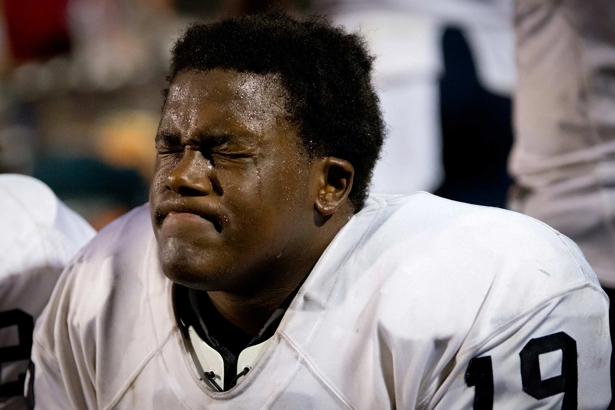 Sophomore tight end Dontae Edwards takes a quick break on the bench in the final quarter of the game. With Hillside leading by just 5 points at 10-15, the game is still far from over.