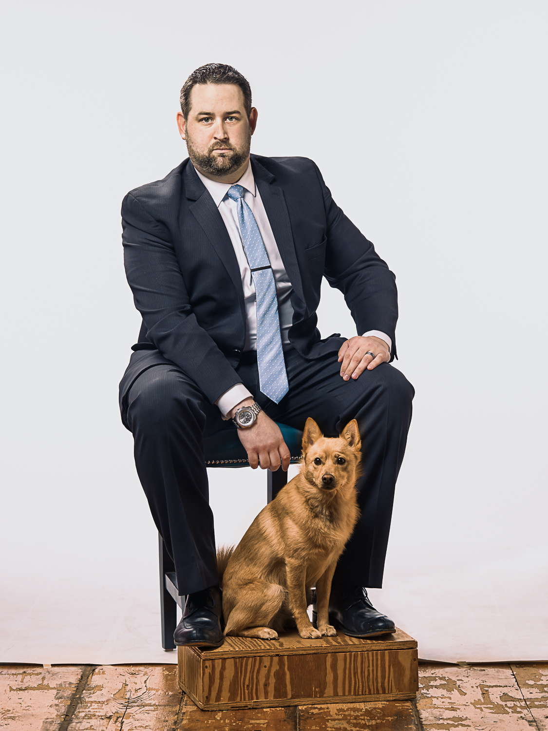 stoic portrait of business man and his dog
