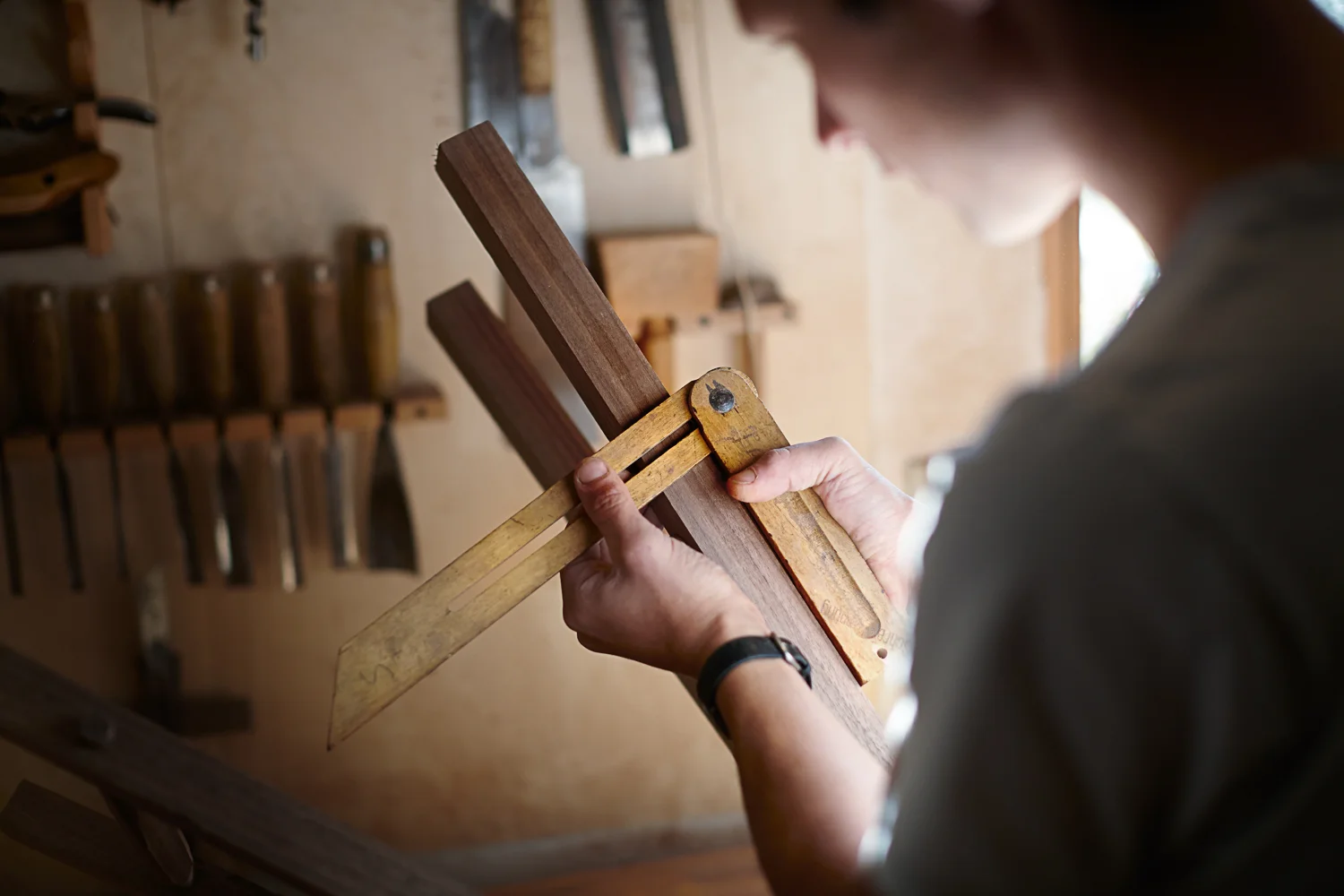 person working with wood tools