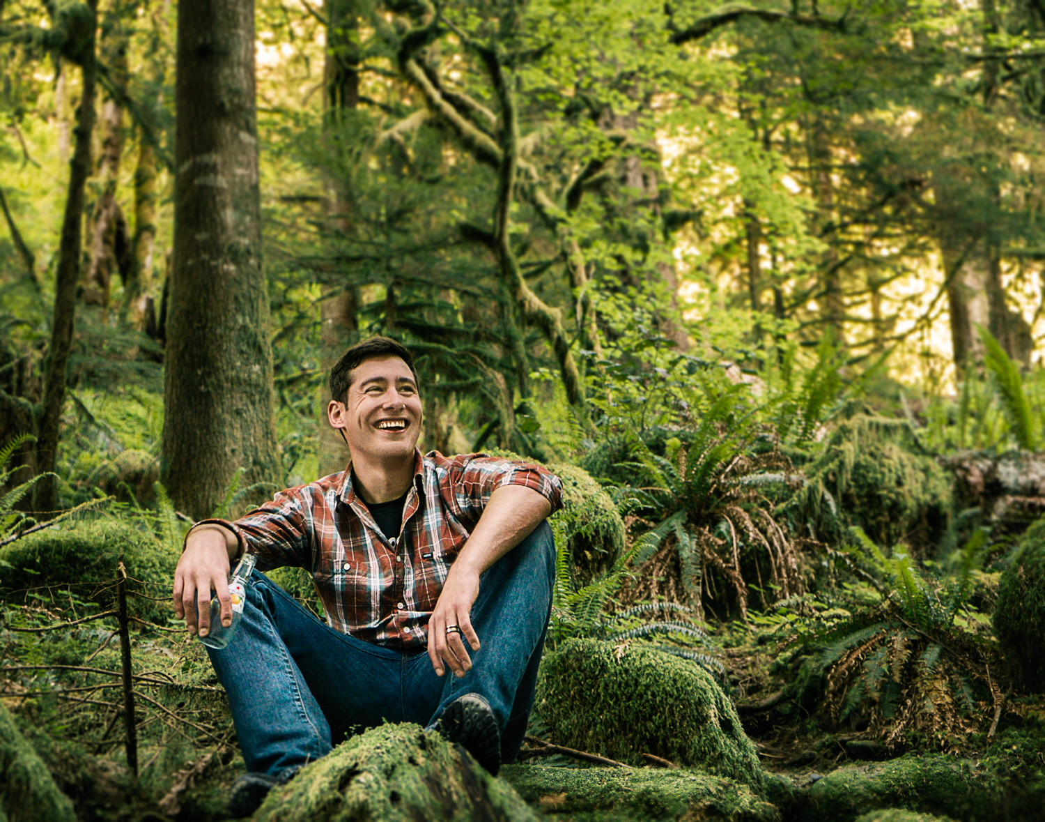 lifestyle portrait of guy sitting in the woods